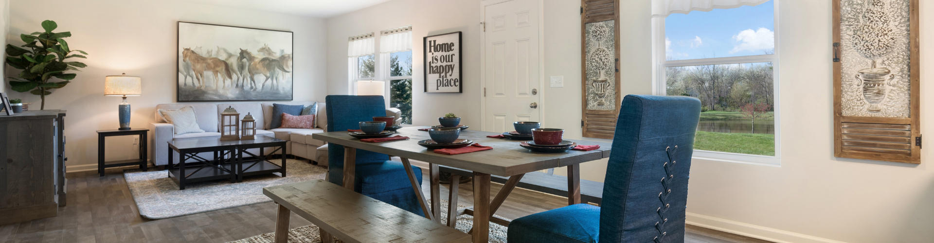 A living room with a table and chairs.