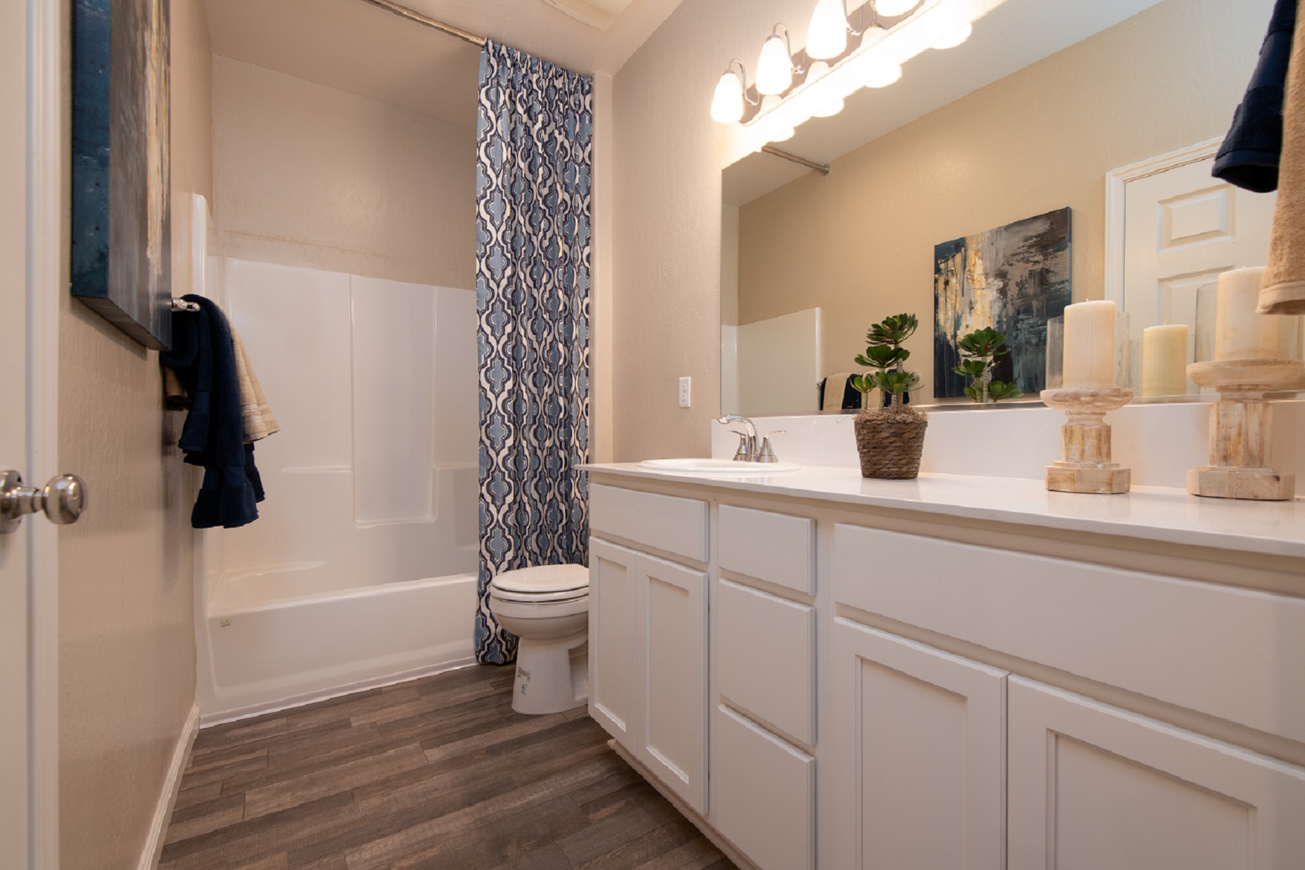 A bathroom with a large mirror.