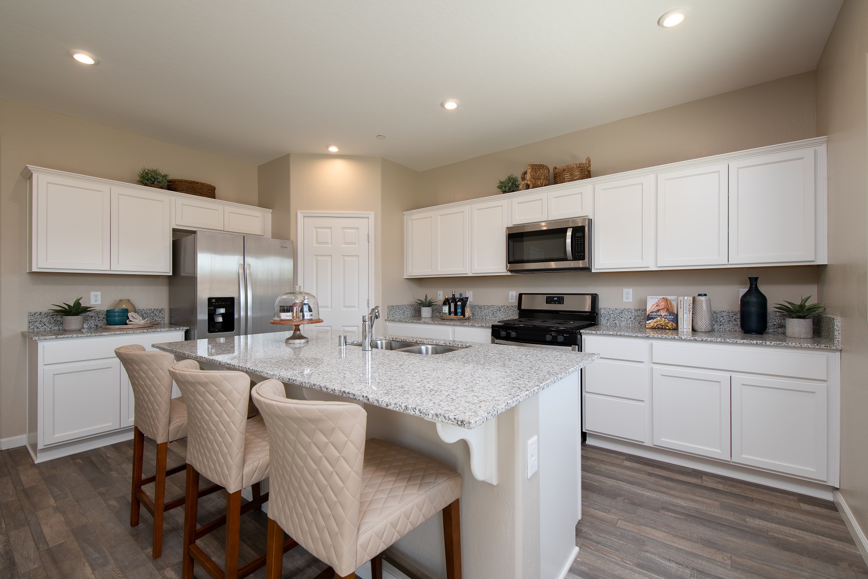 A kitchen with white cabinets.