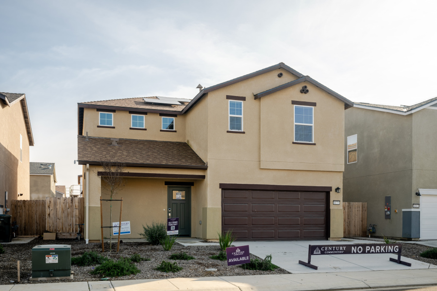 A building with garages and a sign in front of it.