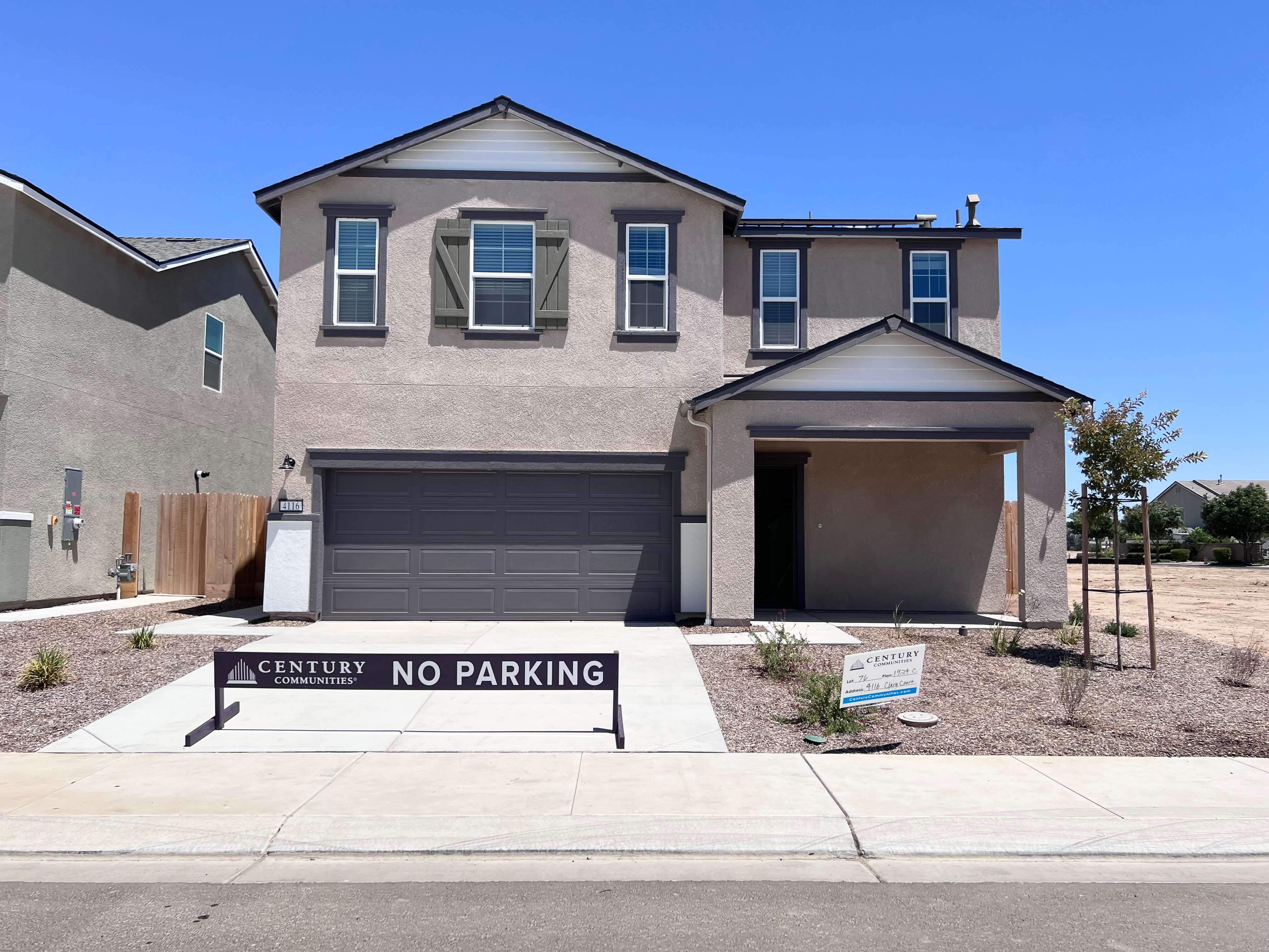 A house with a garage with John Mark Verdier House in the background.