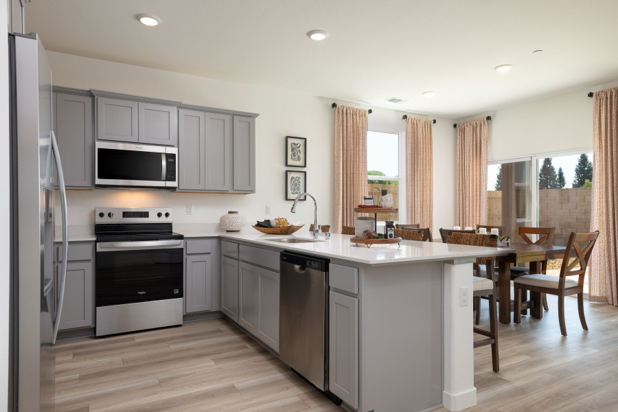 A kitchen with white cabinets.