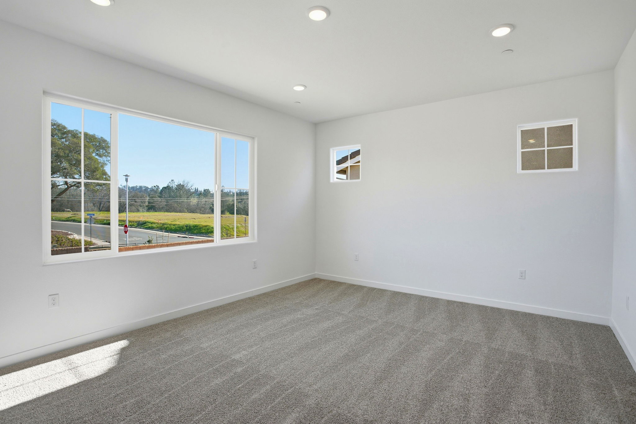 A room with a window and a view of the water.