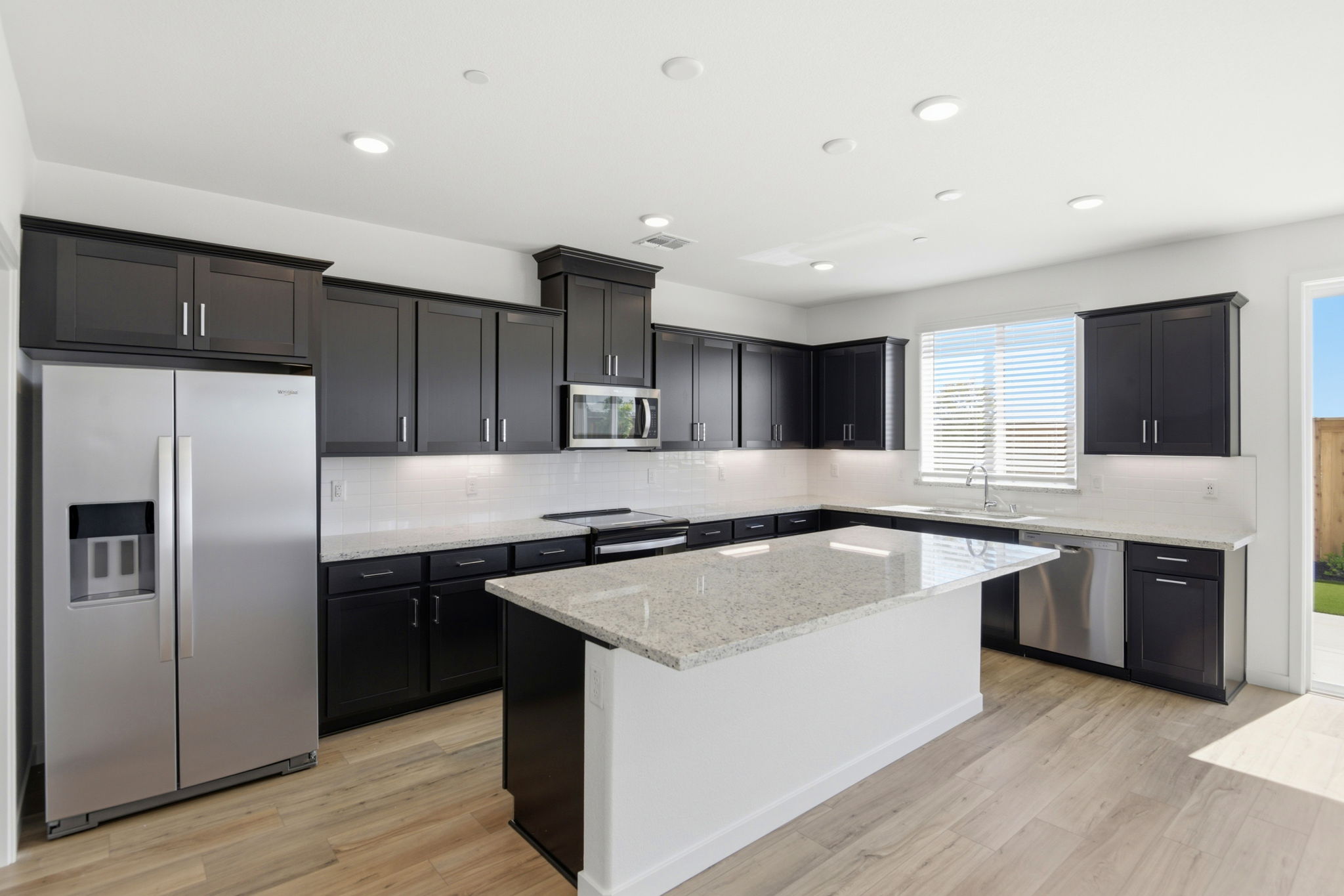 A kitchen with black cabinets.