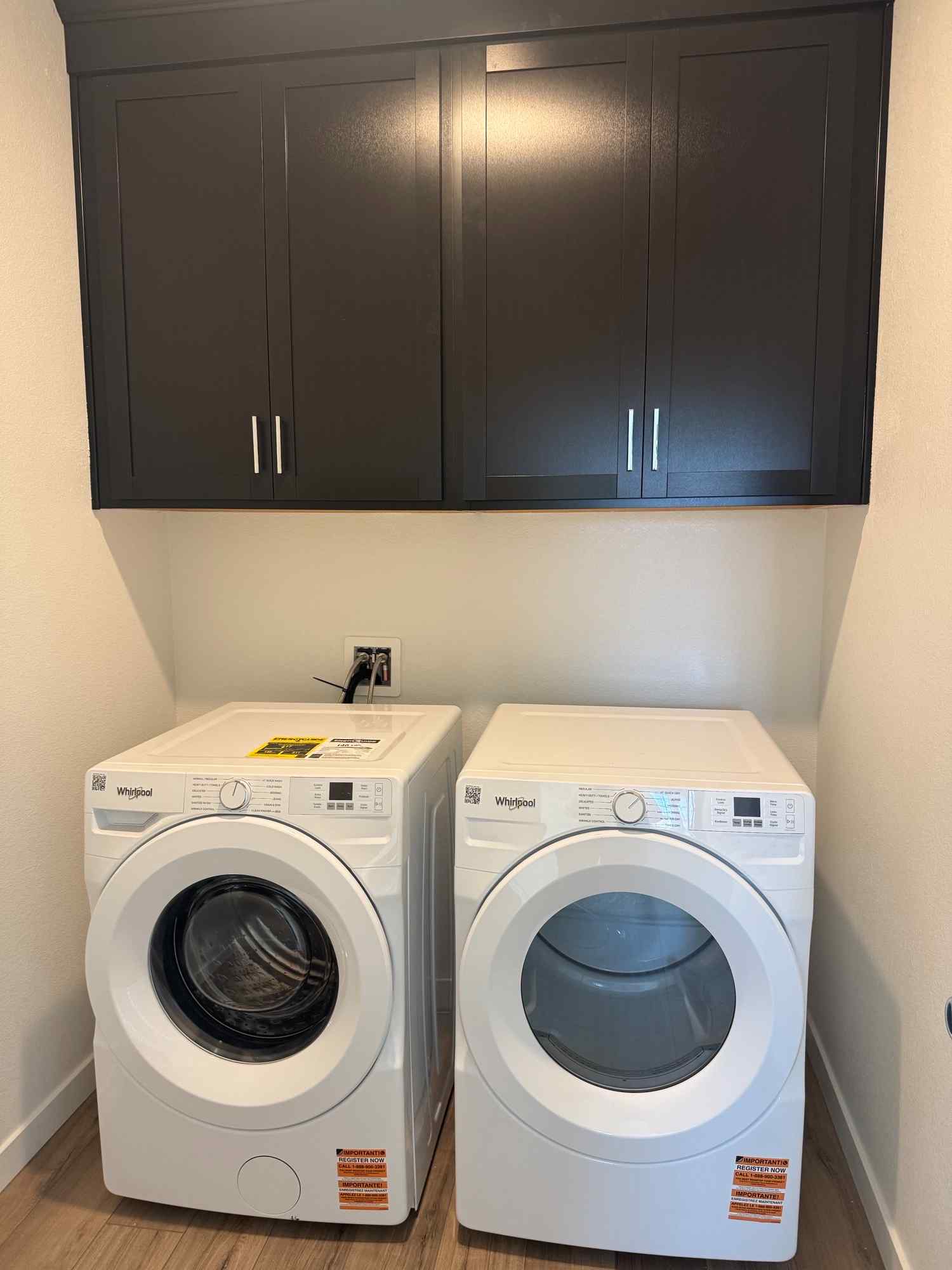 A washing machine and dryer in a room.