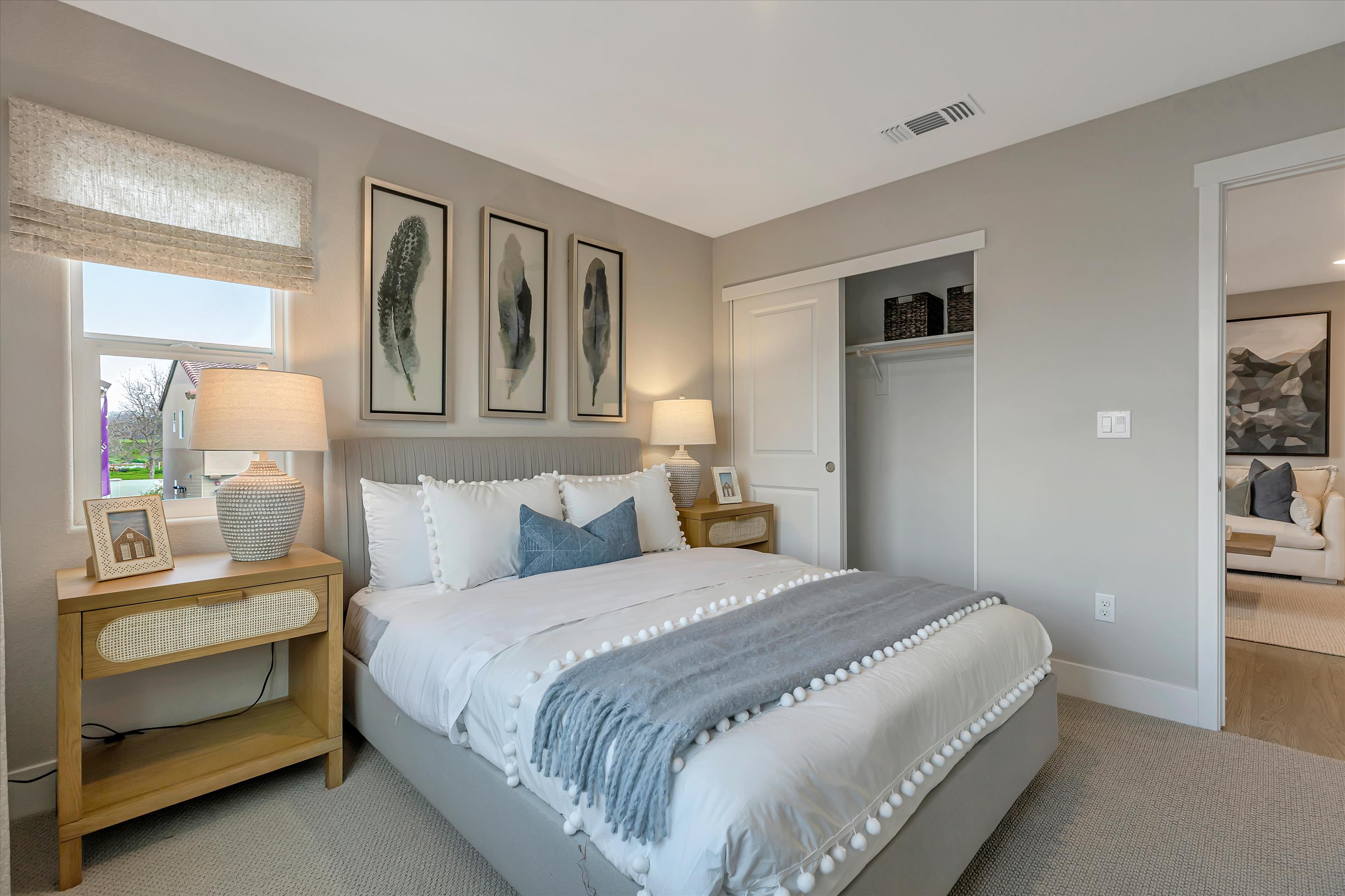 A bedroom with a bed and a mirror.