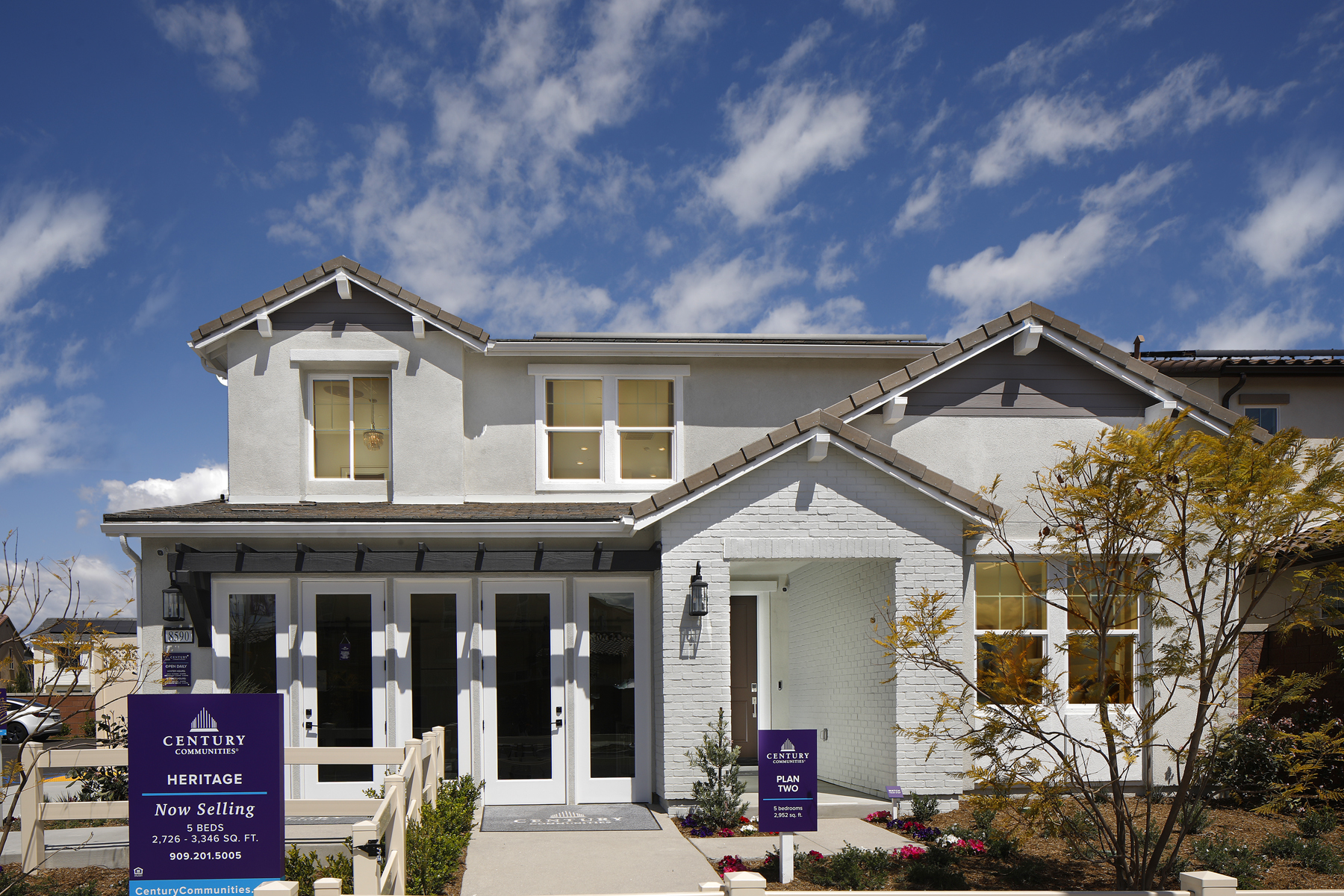 A white house with a sign in front of it.