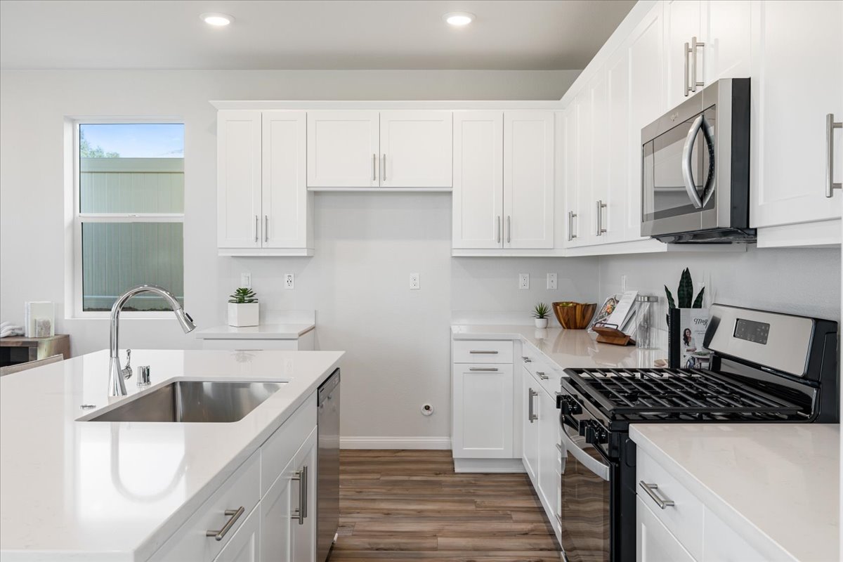 A kitchen with white cabinets.