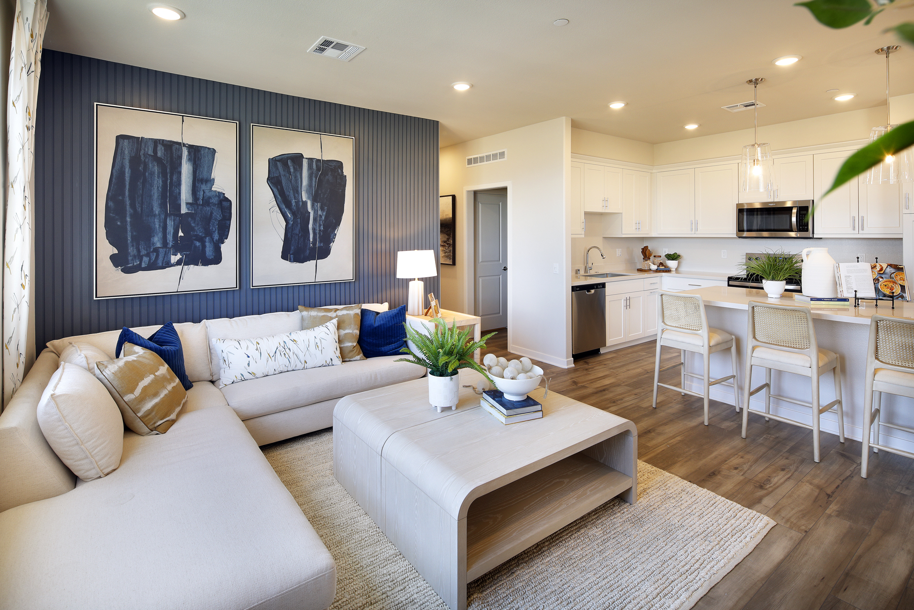 A living room with a large kitchen.