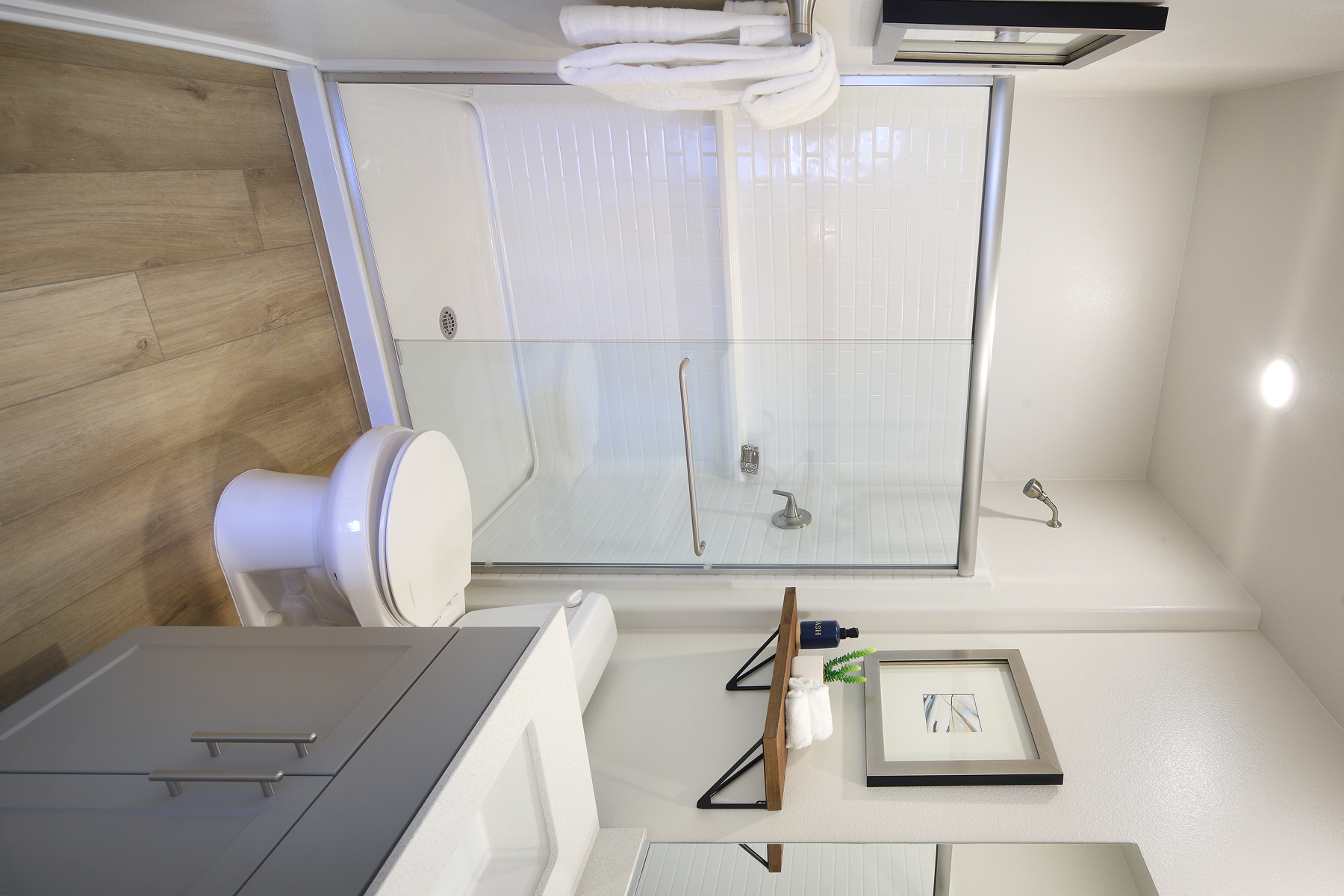 A bathroom with a shower unit and toilet.