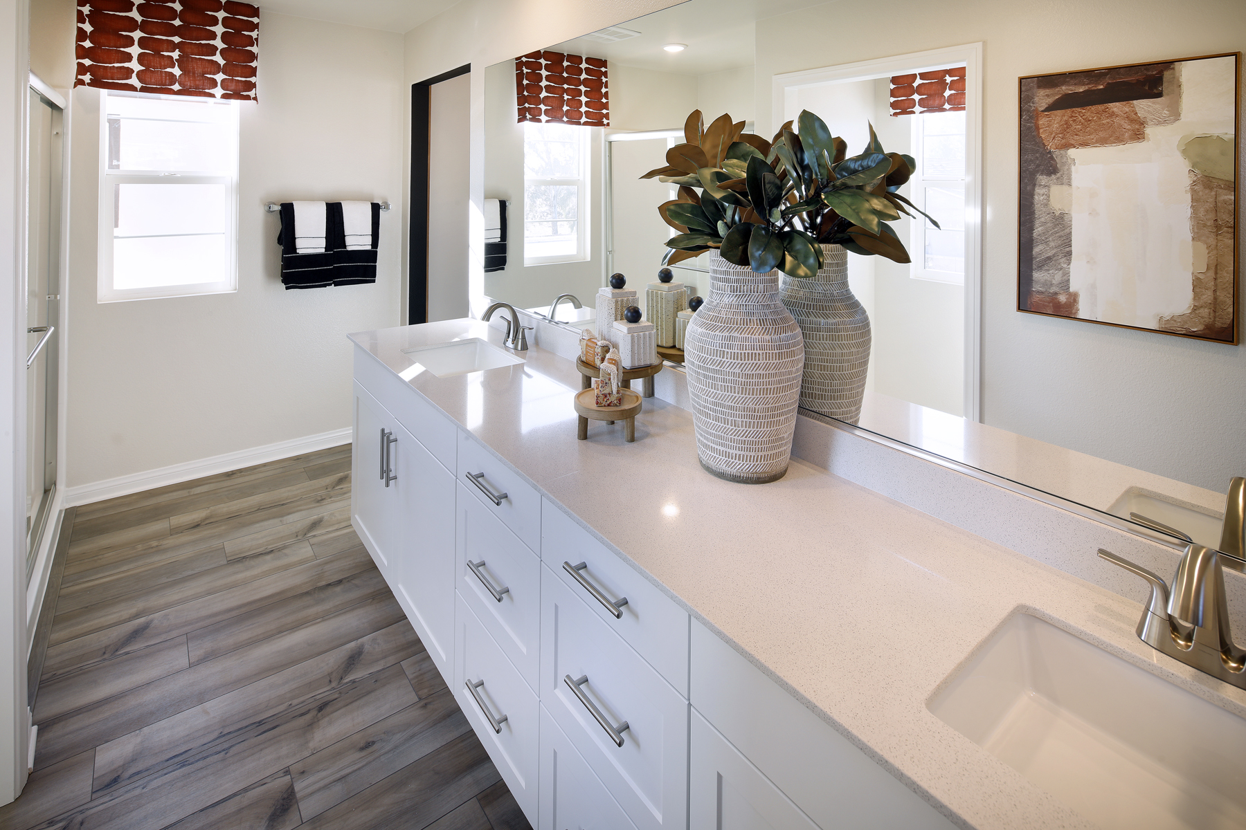 A bathroom with a large mirror.