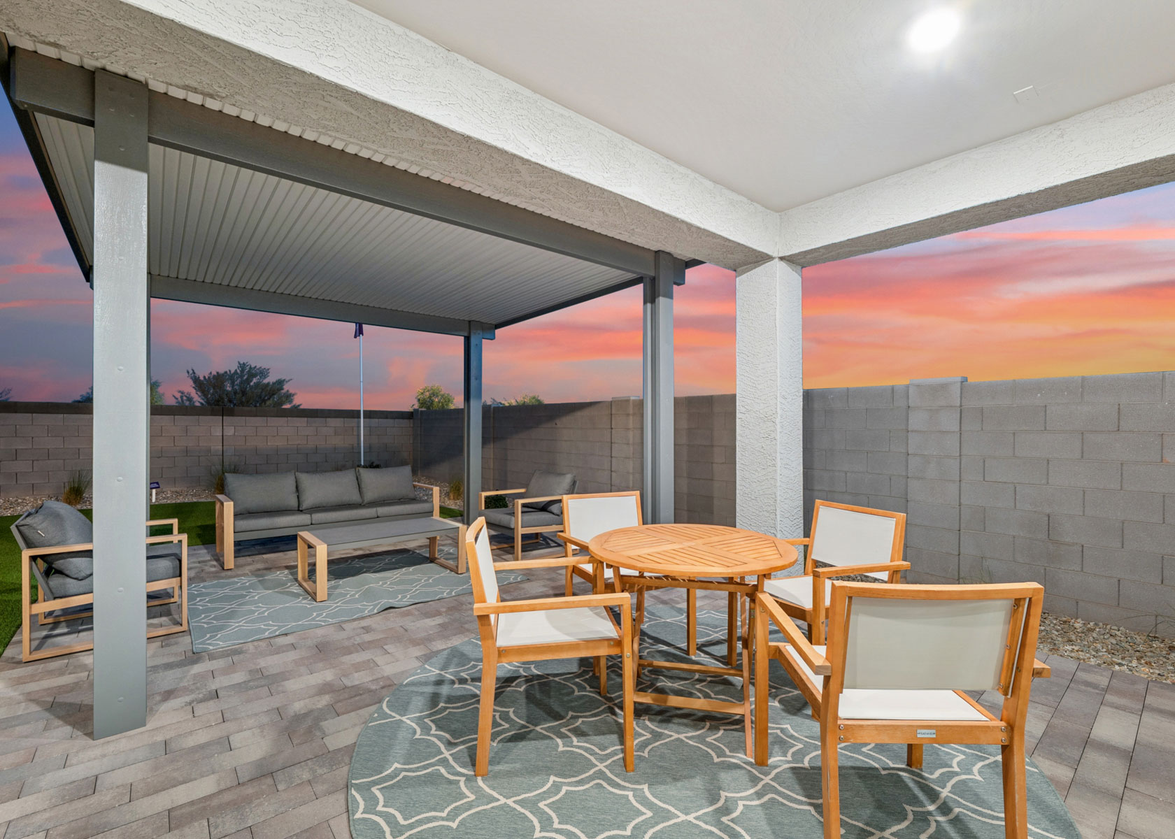 A patio with tables and chairs.