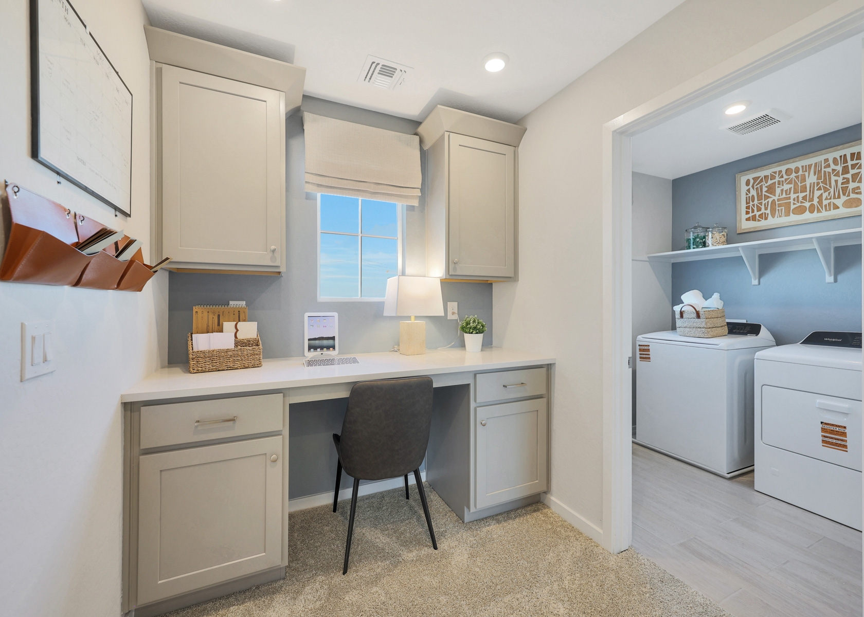A kitchen with white cabinets.