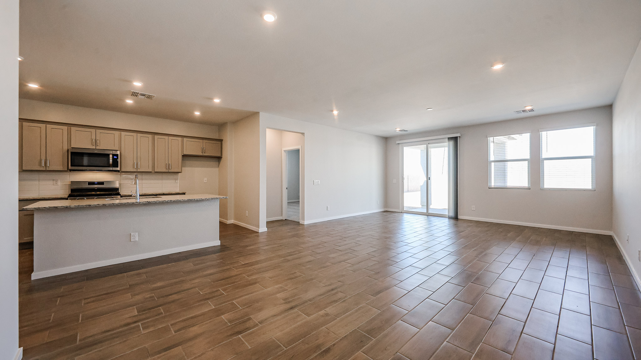 A large kitchen with wooden floors.