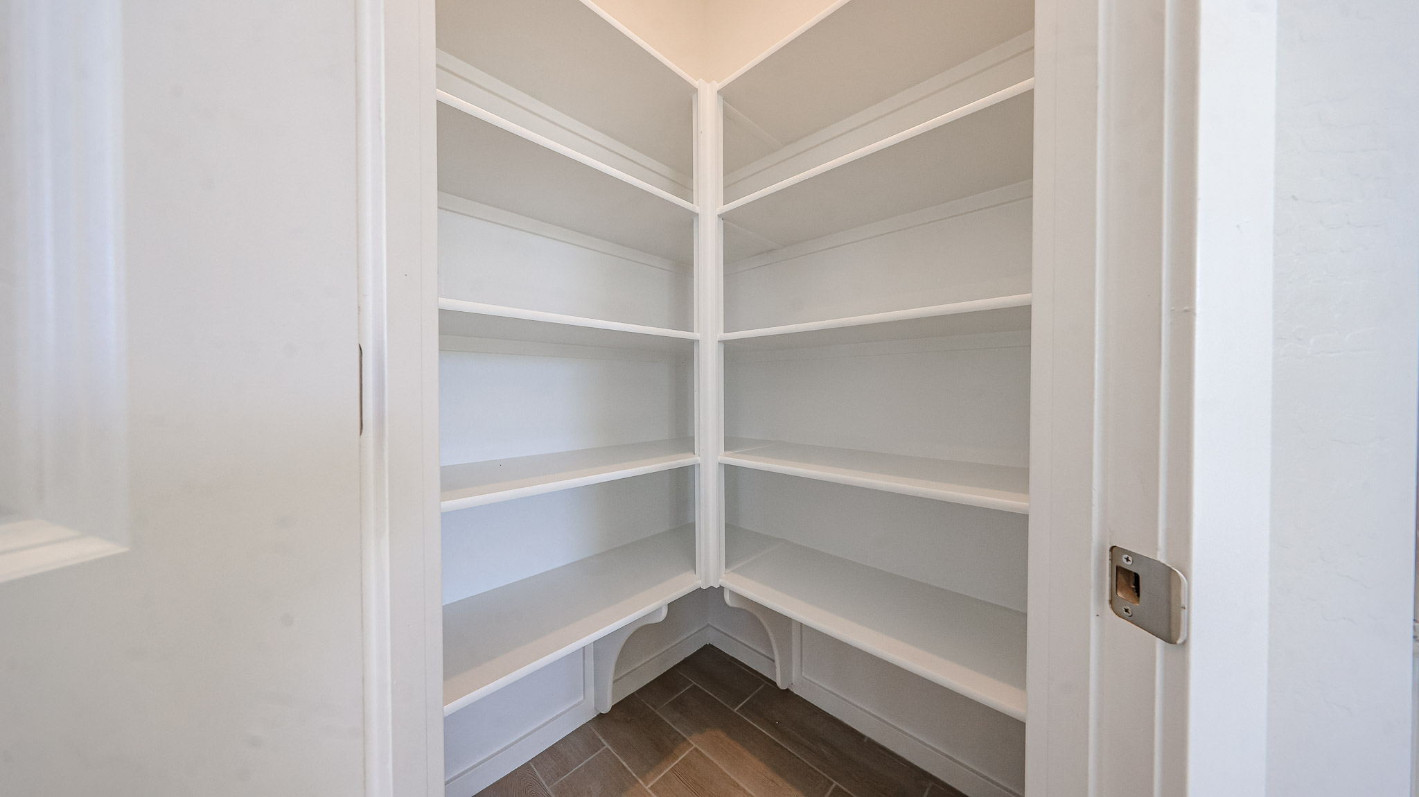 A white shelf with a door.