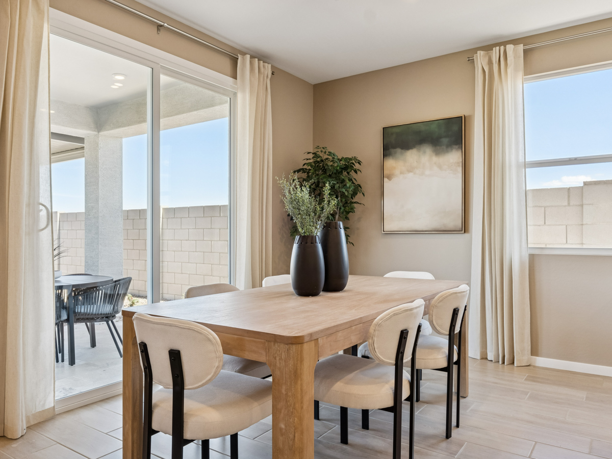 A dining room table with chairs.