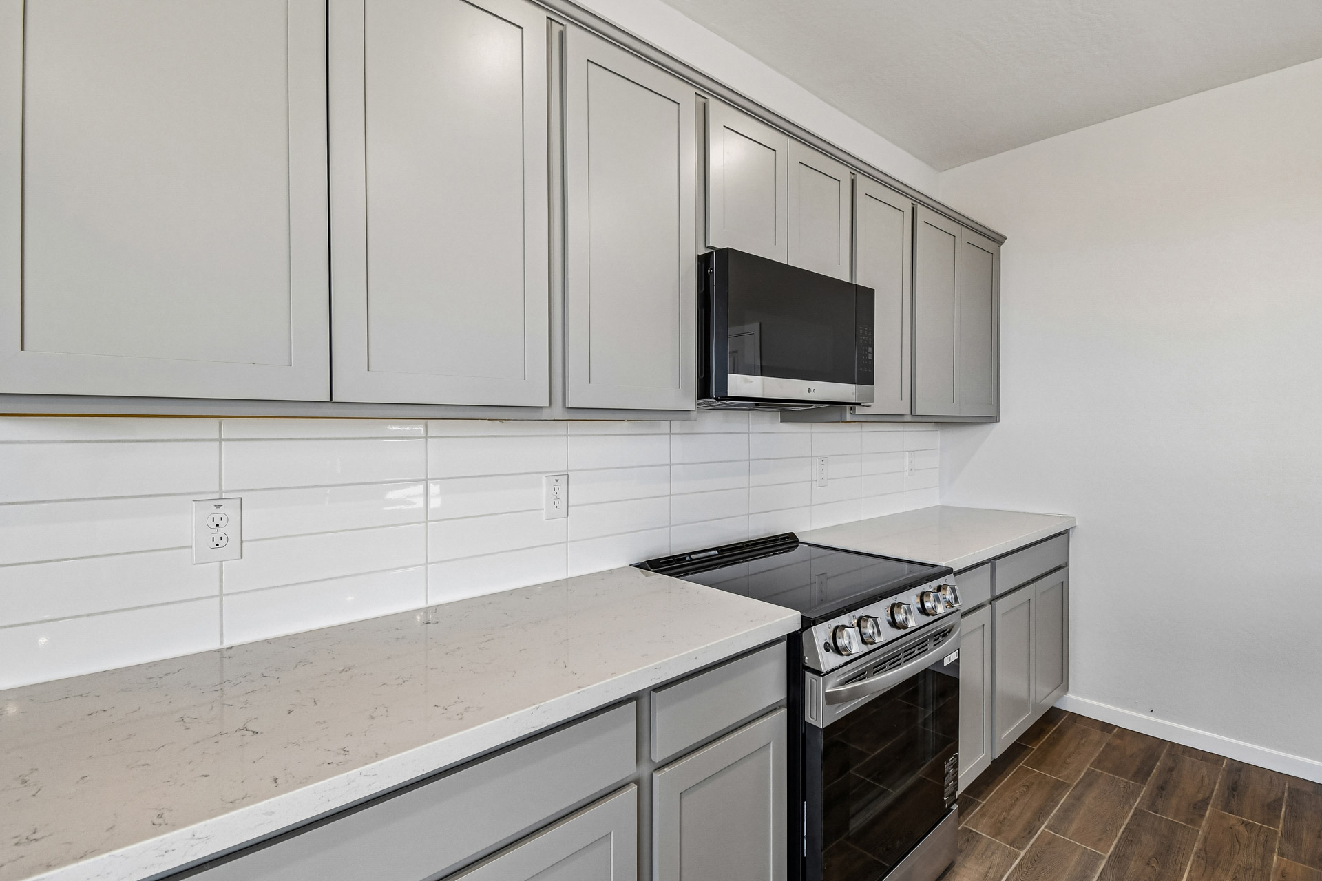 A kitchen with white cabinets.