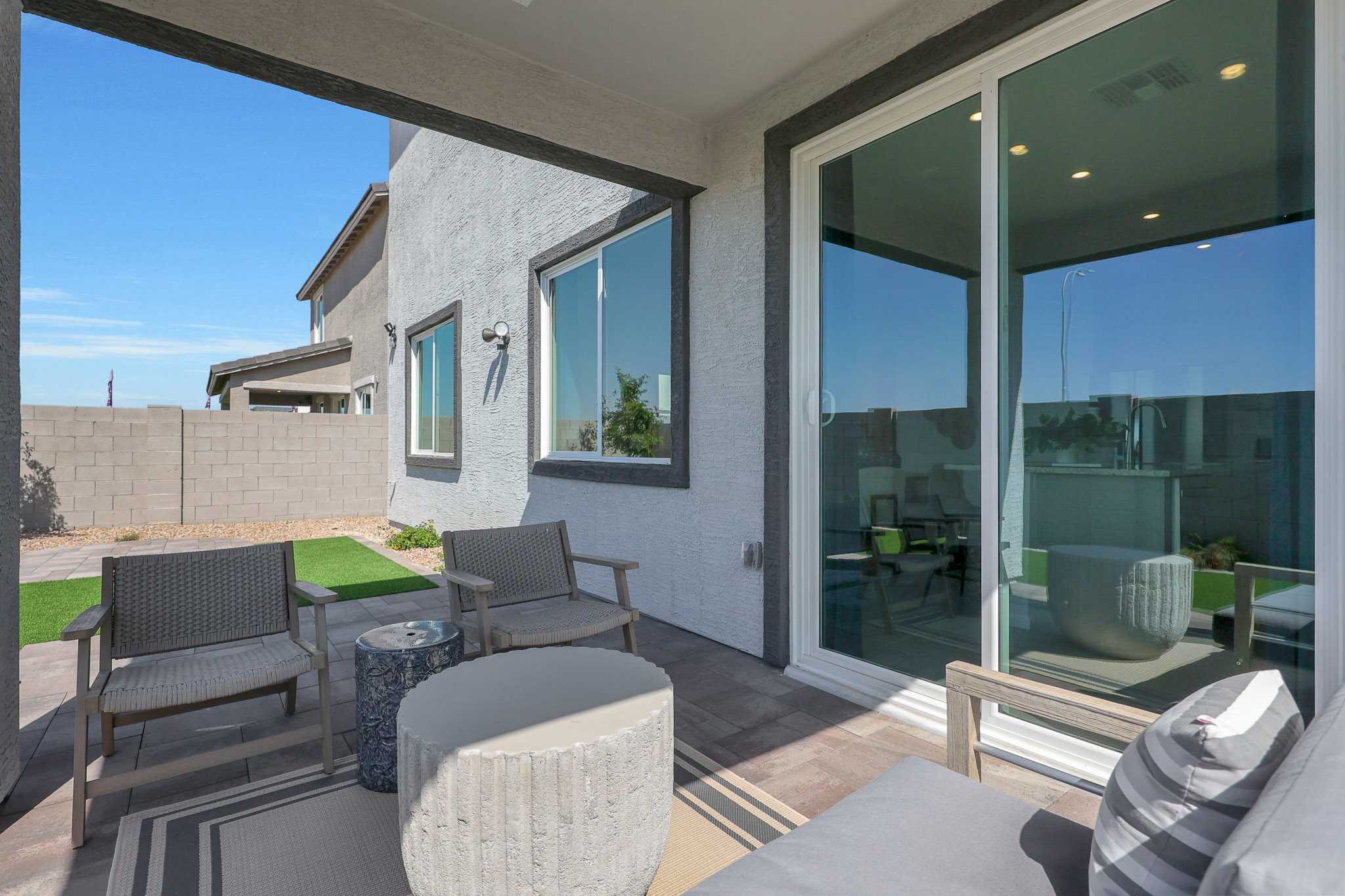 A patio with chairs and a table.