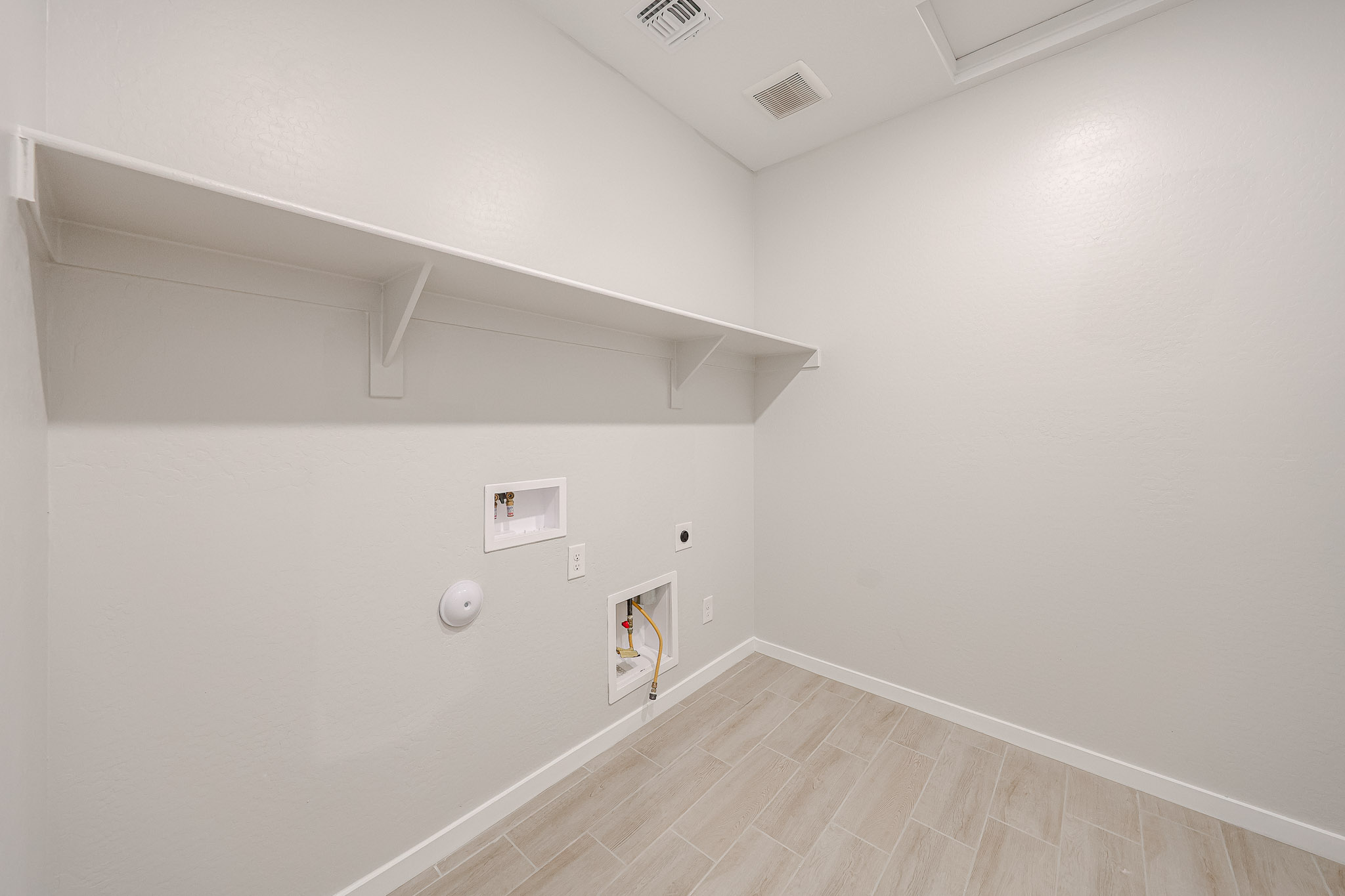 A room with a wood floor and white walls.