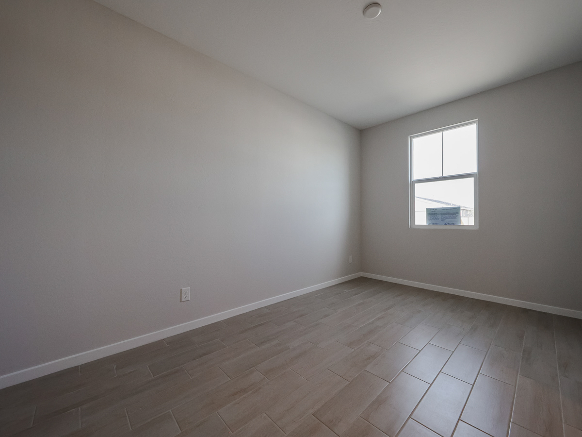 A room with a tile floor and a window.