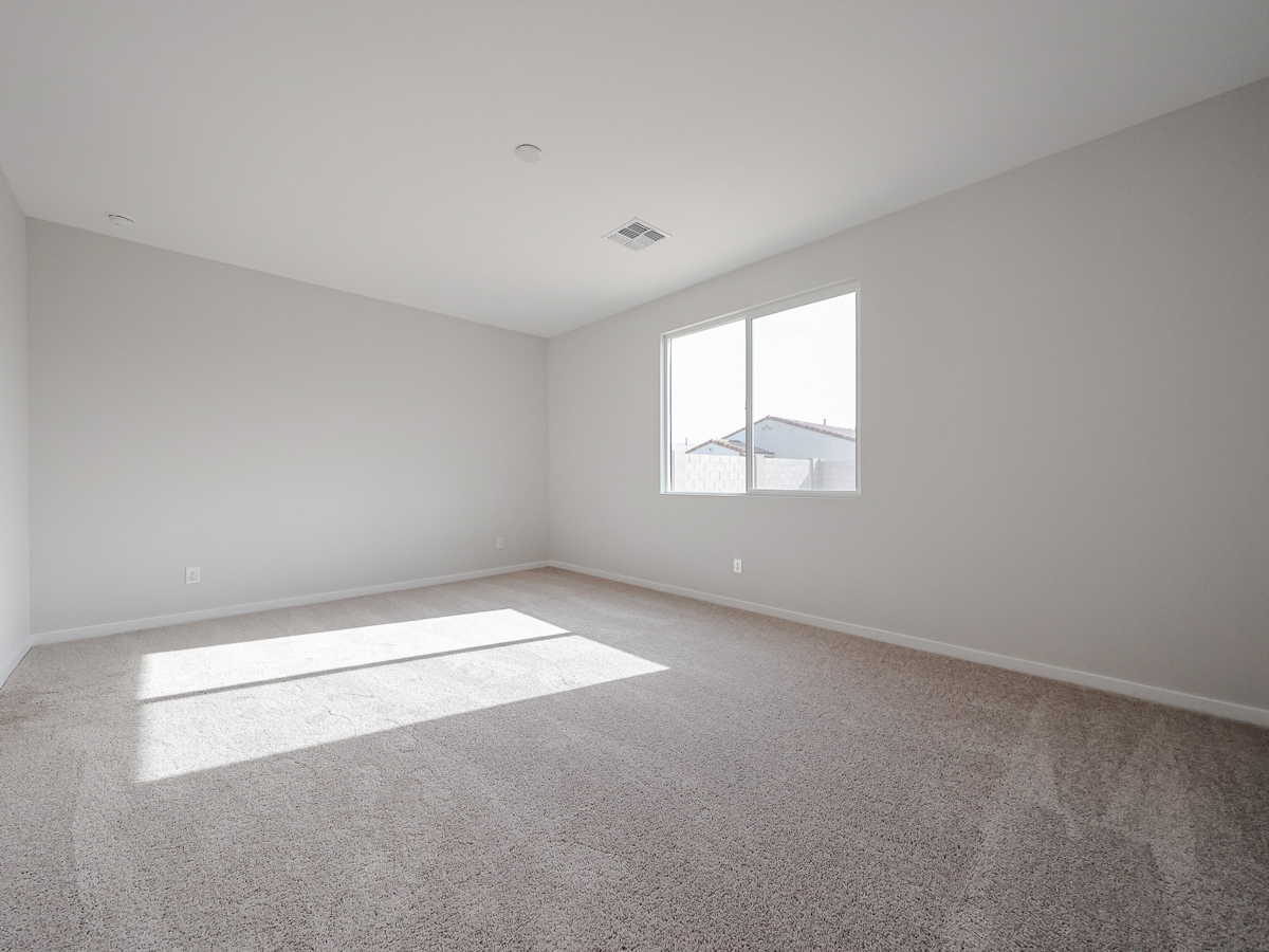 A room with a rug and a window.