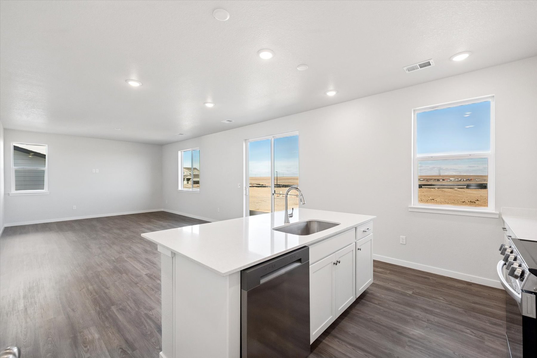 A kitchen with white cabinets.