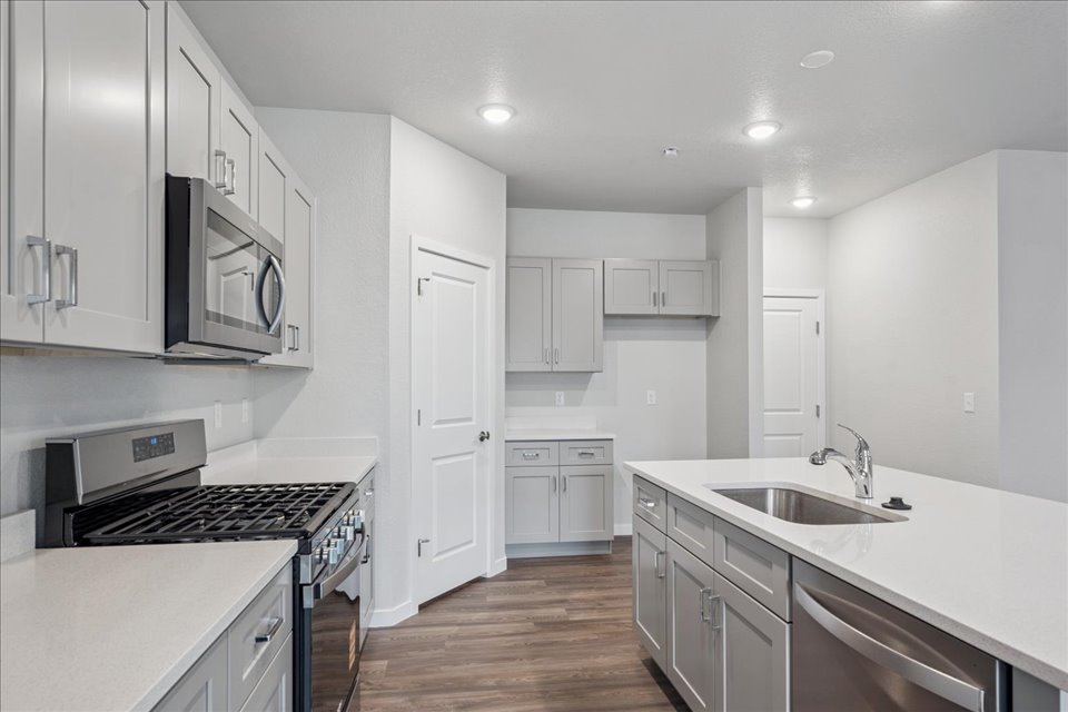 A kitchen with white cabinets.