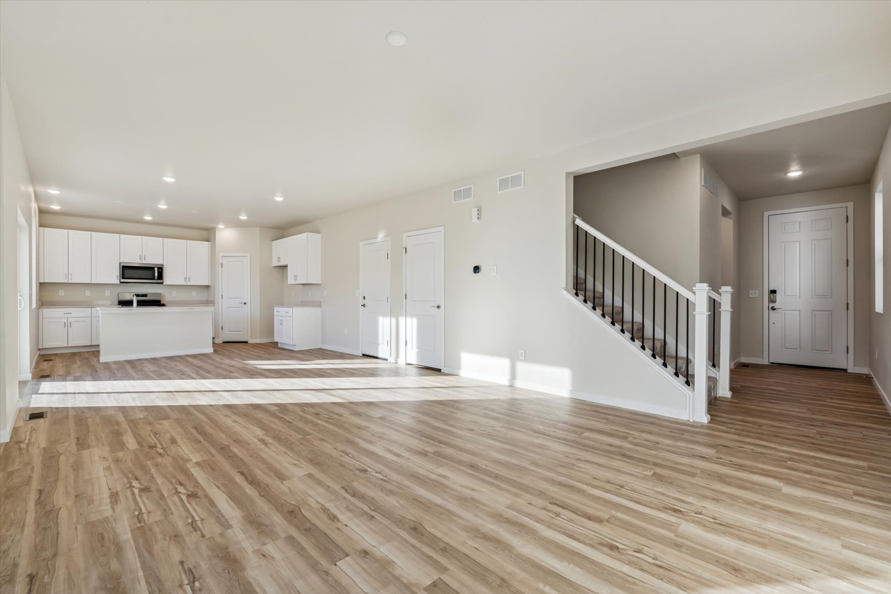 A large empty room with white doors.