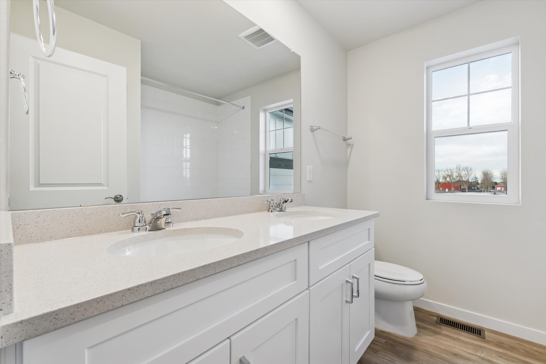 A bathroom with a large mirror.