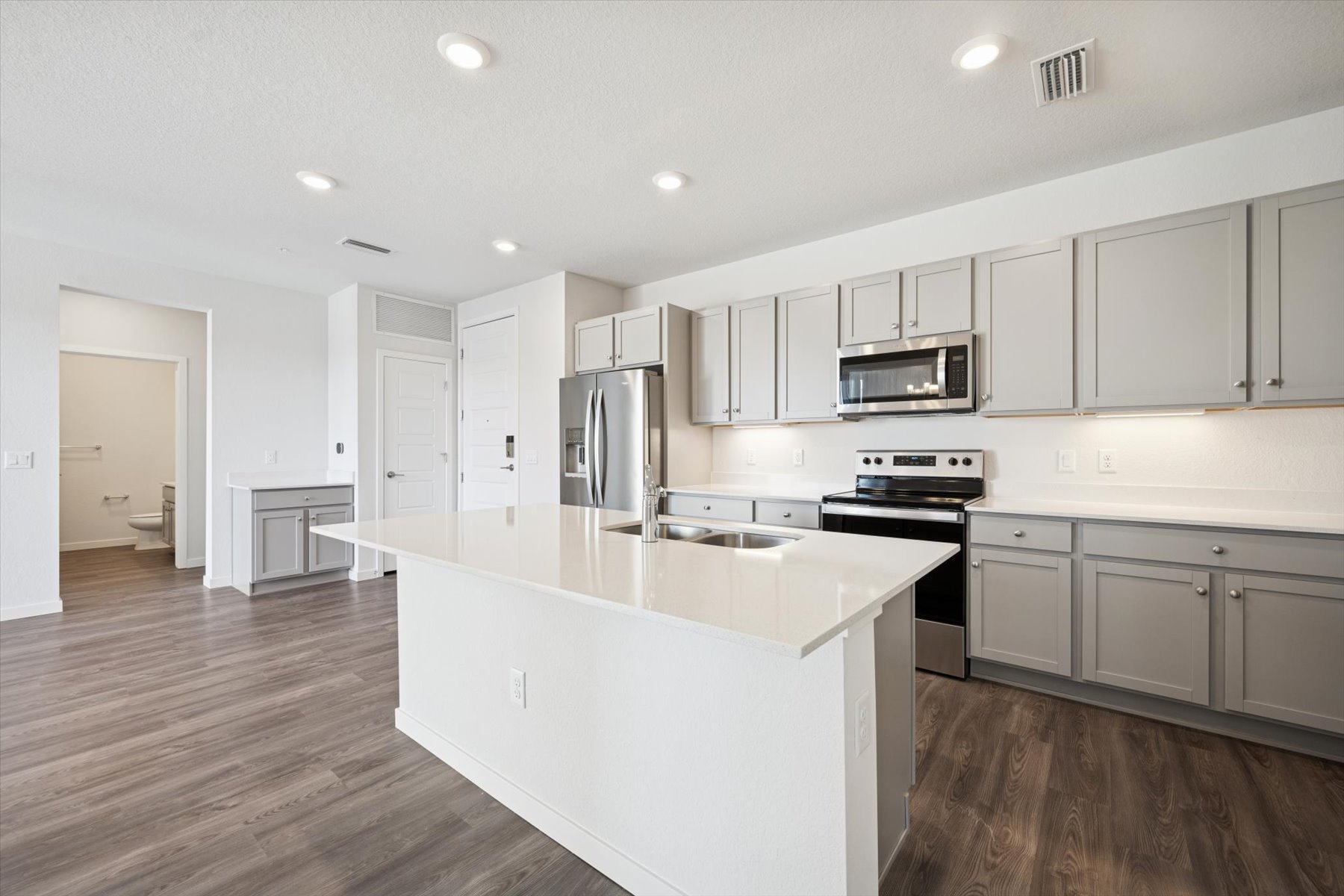 A kitchen with white cabinets.