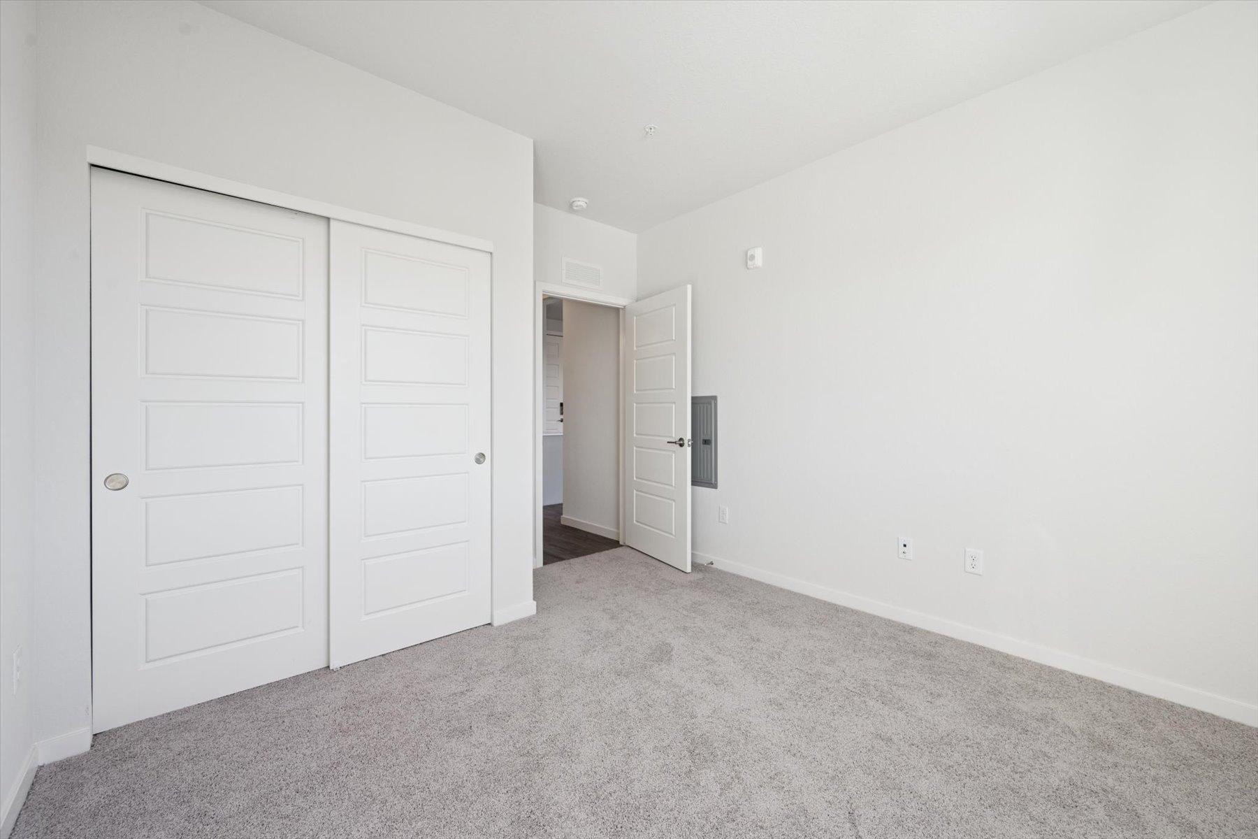 A hallway with white doors.