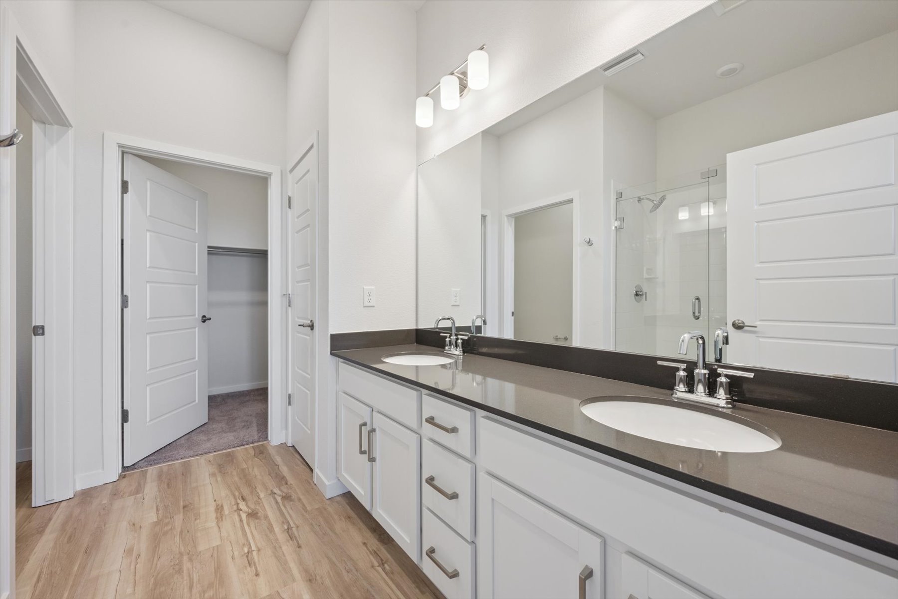 A bathroom with a large mirror.