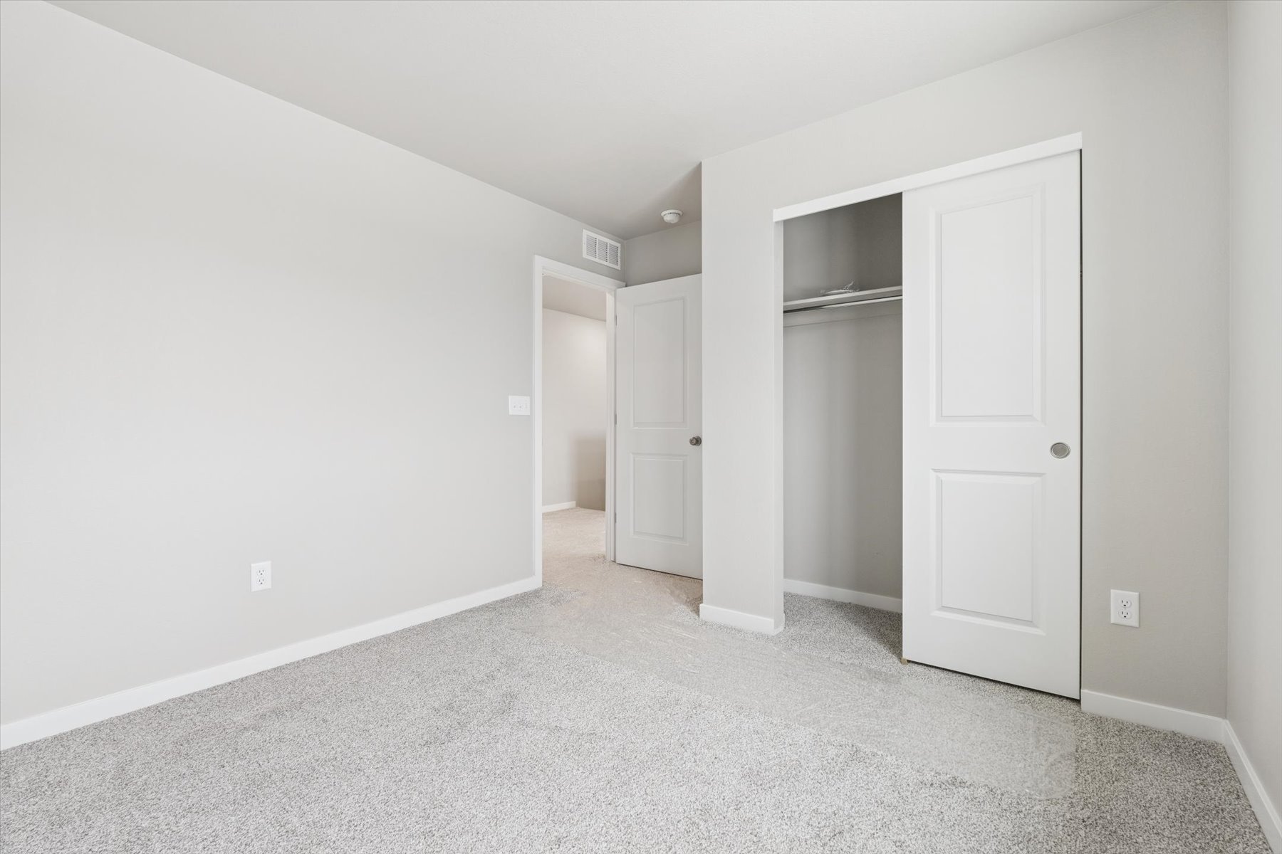 A hallway with white doors.