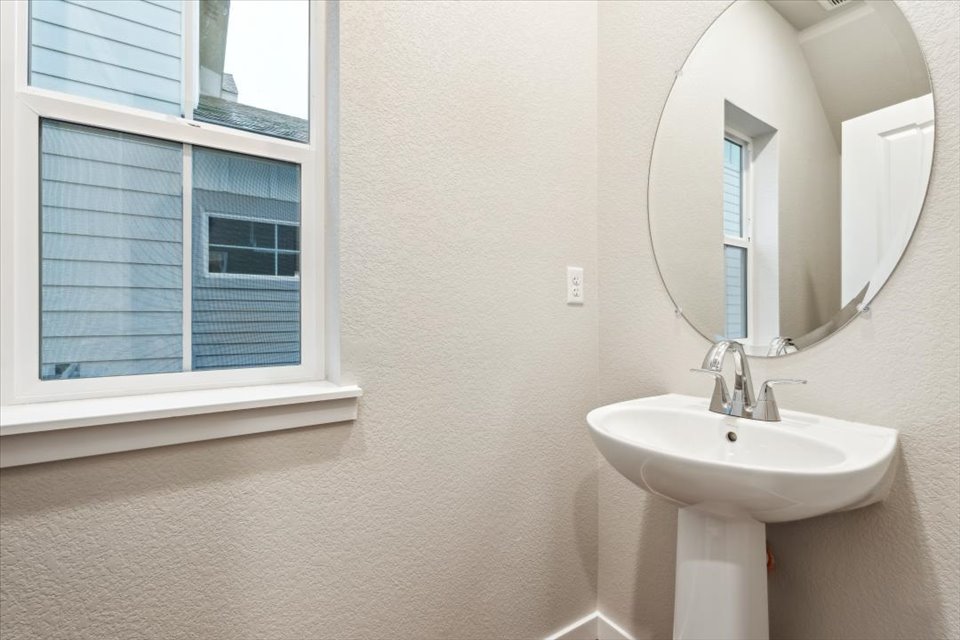 A bathroom with a mirror and sink.