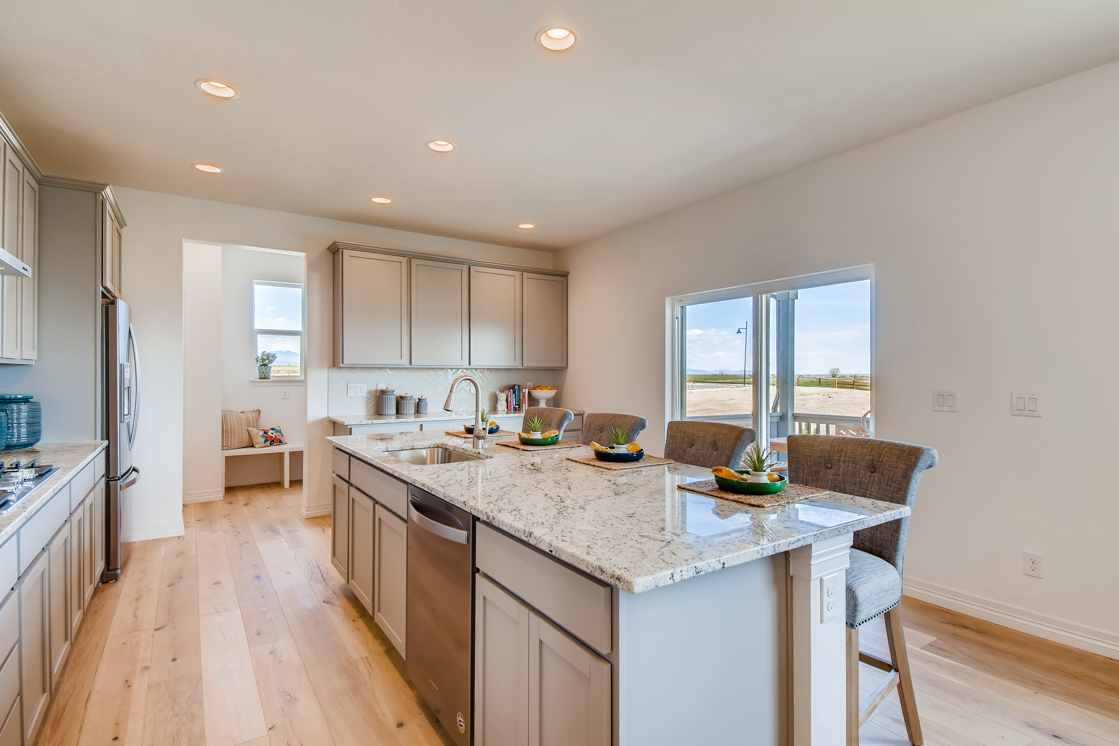 A kitchen with a marble island.