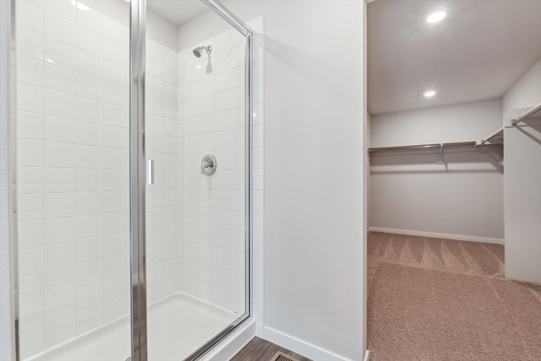 A shower with a glass door.