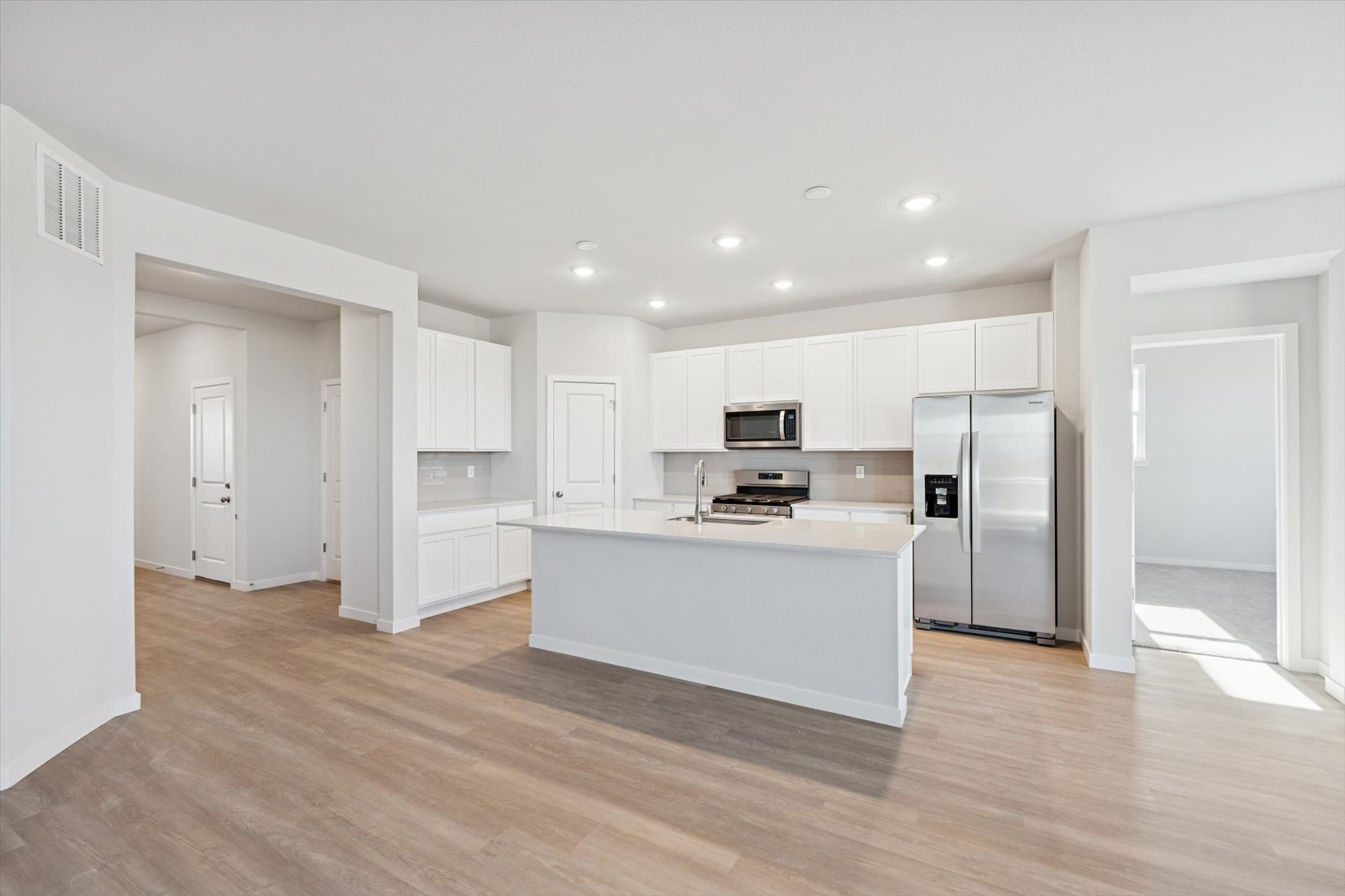 A large kitchen with white cabinets.