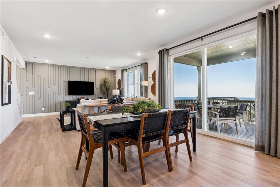 A large dining room with a large window.