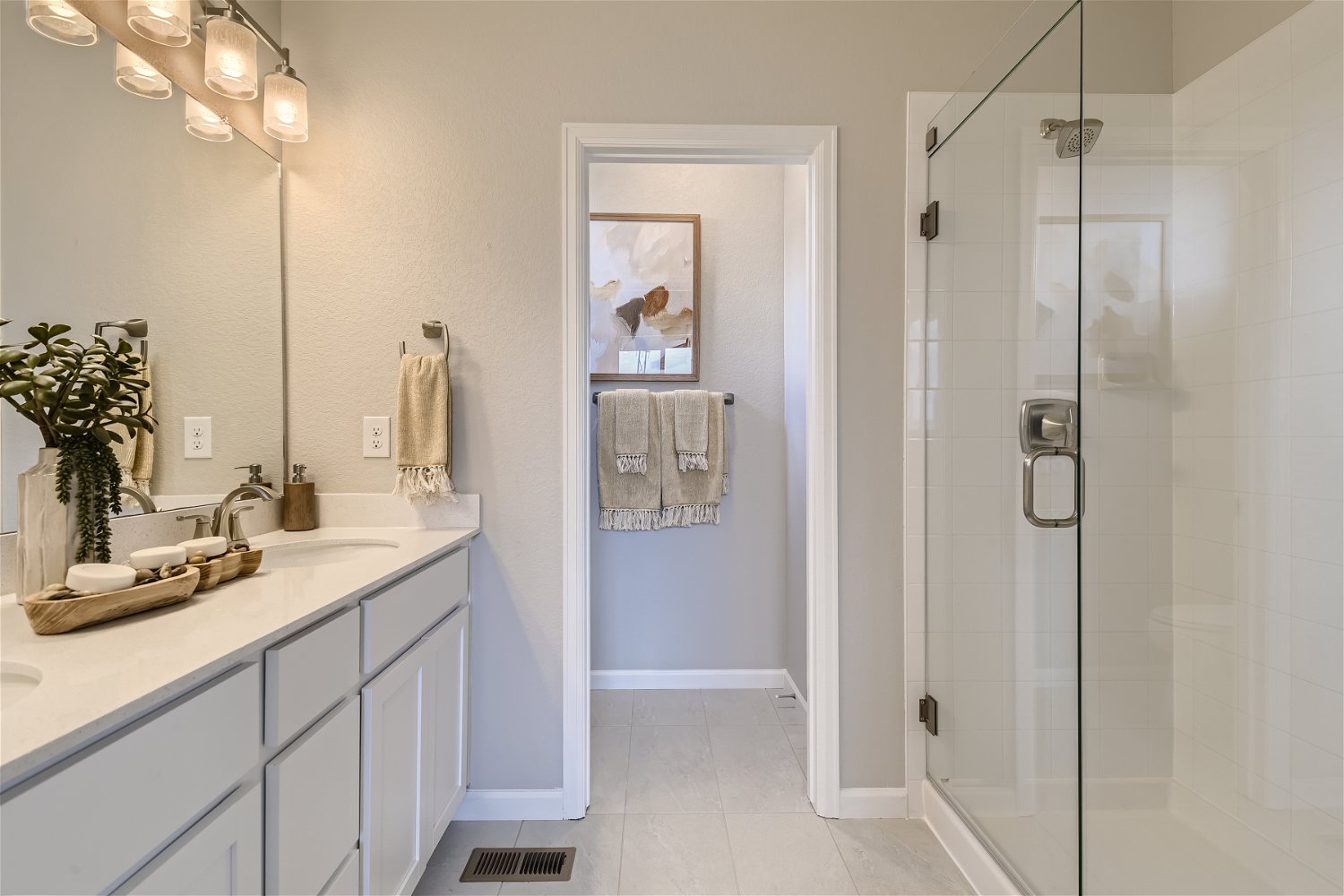 A bathroom with a shower unit and a sink.
