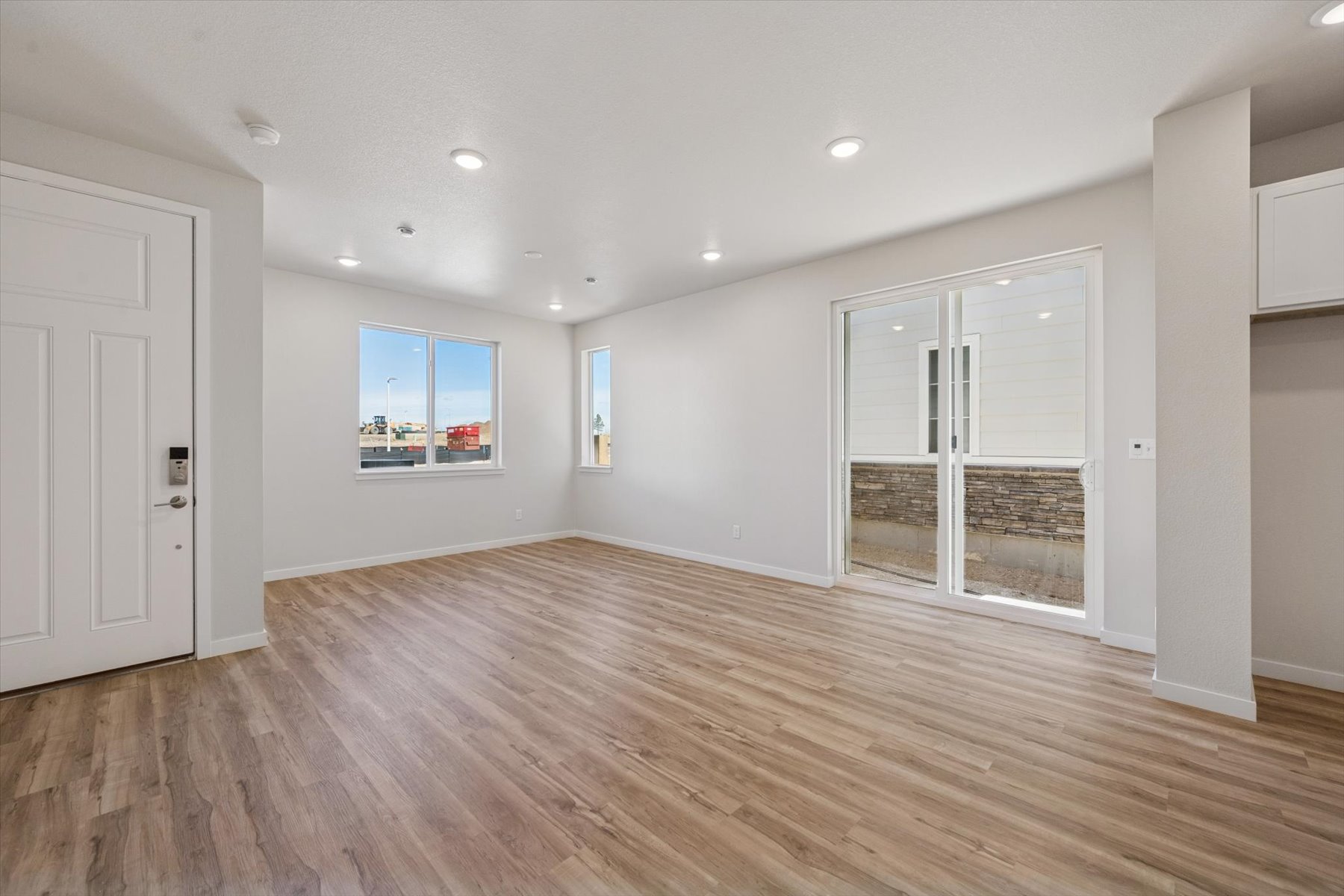 A room with a wood floor and white walls.