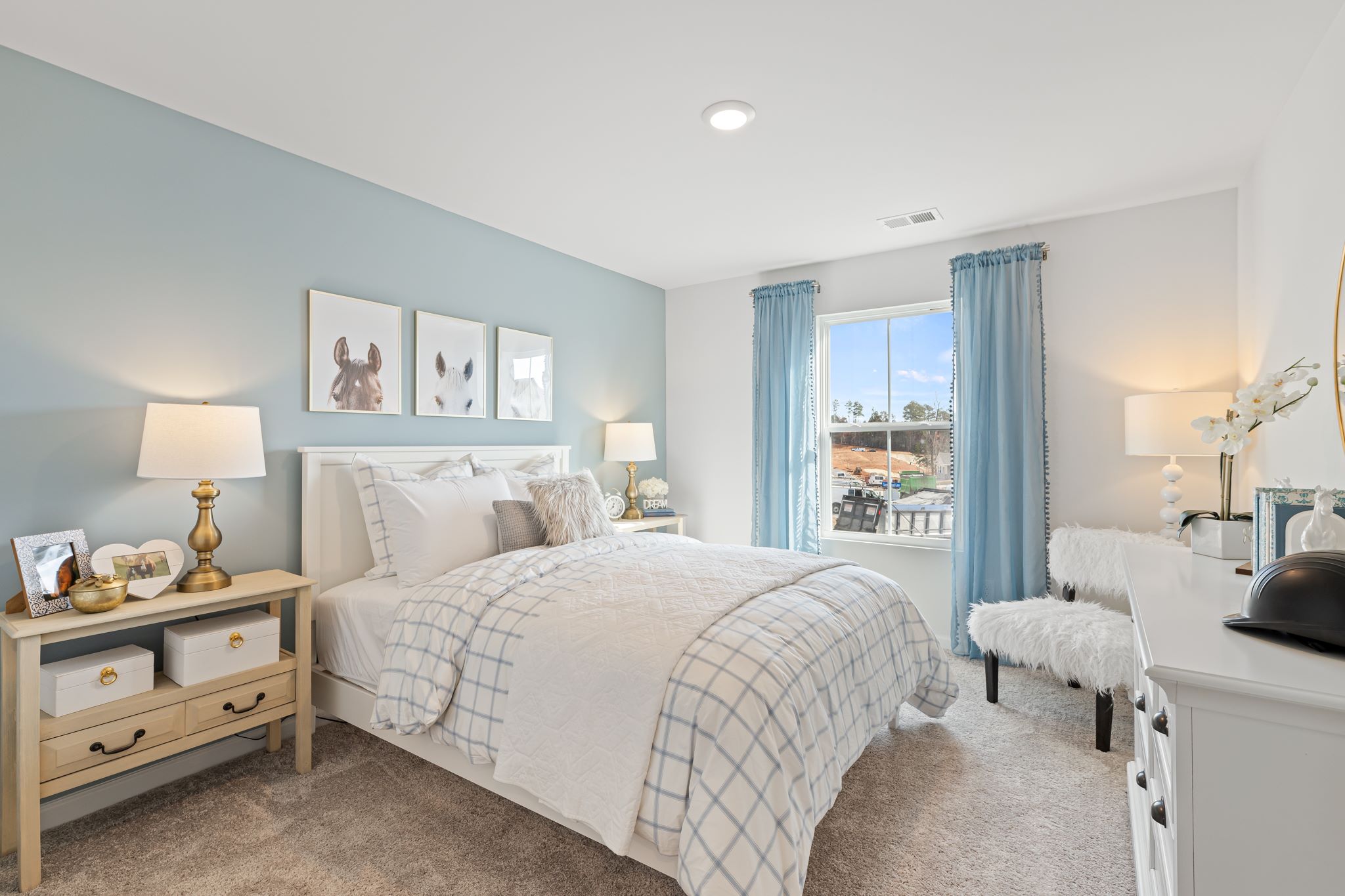 A bedroom with a large window.