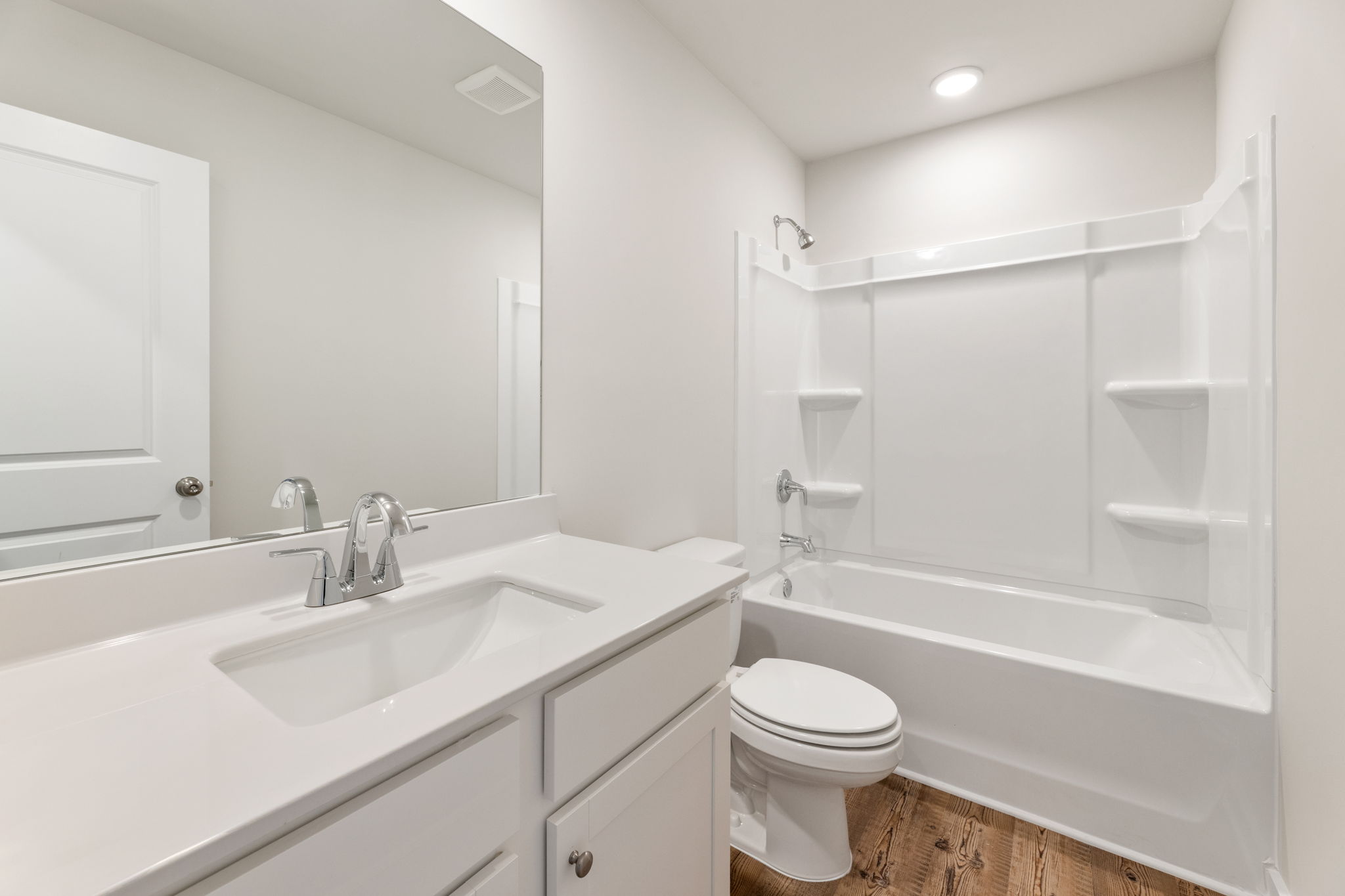 A bathroom with a tub sink and toilet.