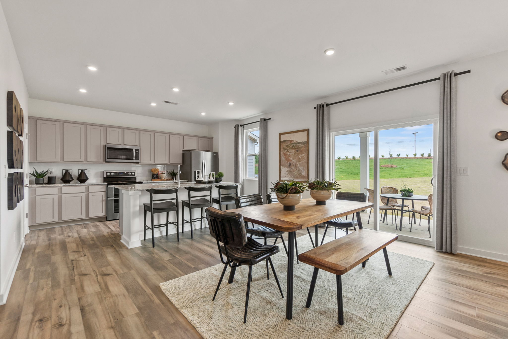 A kitchen with a dining table and chairs.