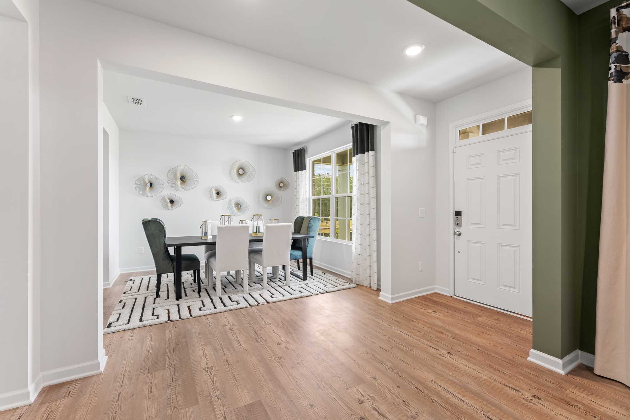 A dining room with a wood floor.