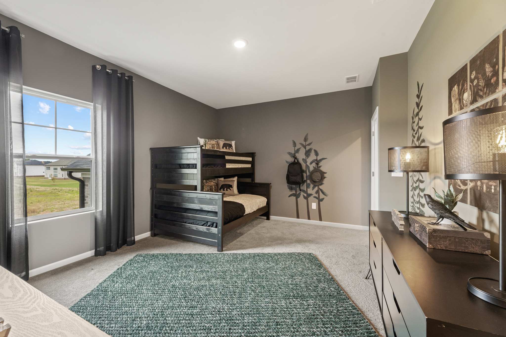 A large bedroom with a large window.