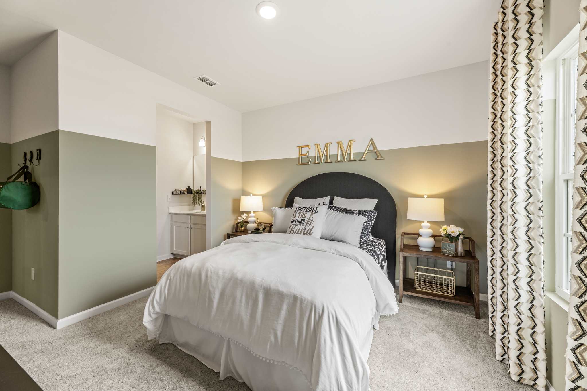 A bedroom with a bed and lamps.