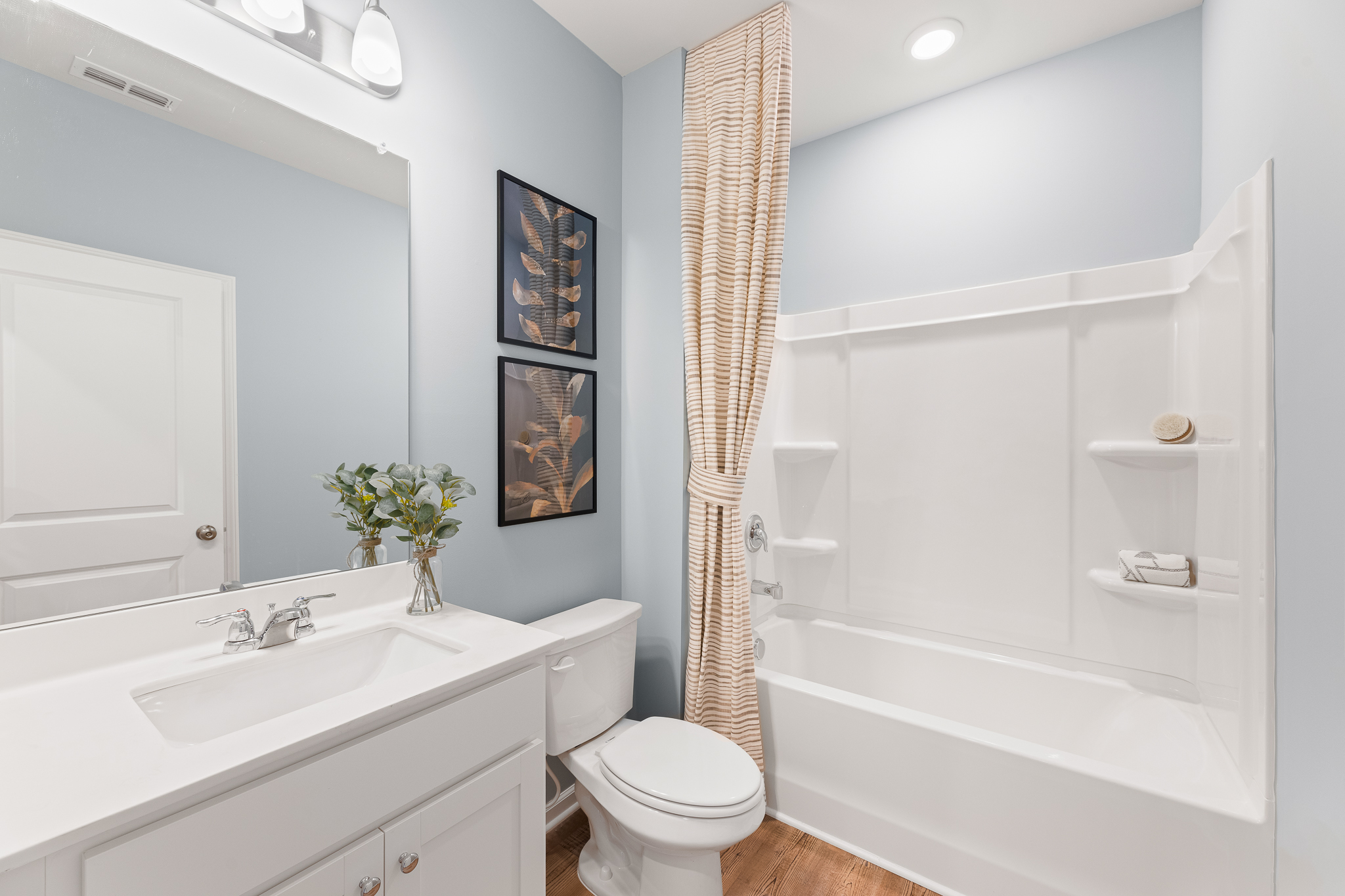 A bathroom with a tub toilet and sink.