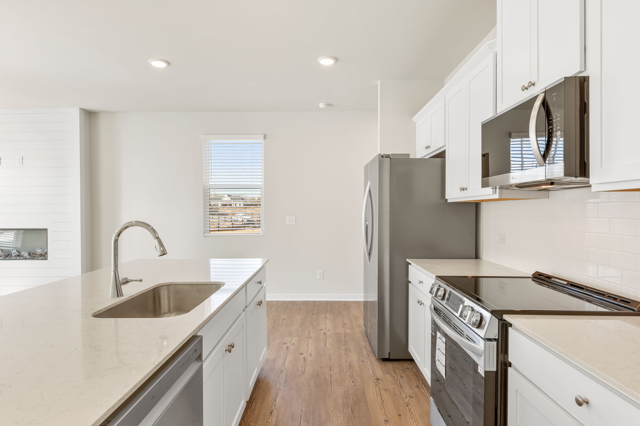 A kitchen with white cabinets.