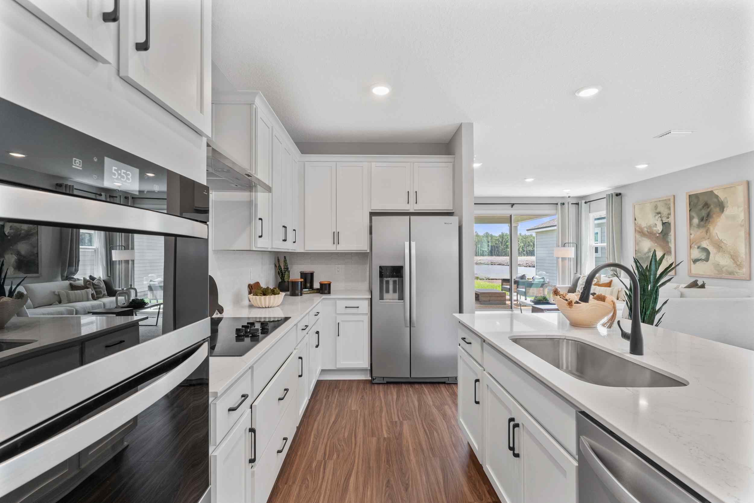 A kitchen with white cabinets.