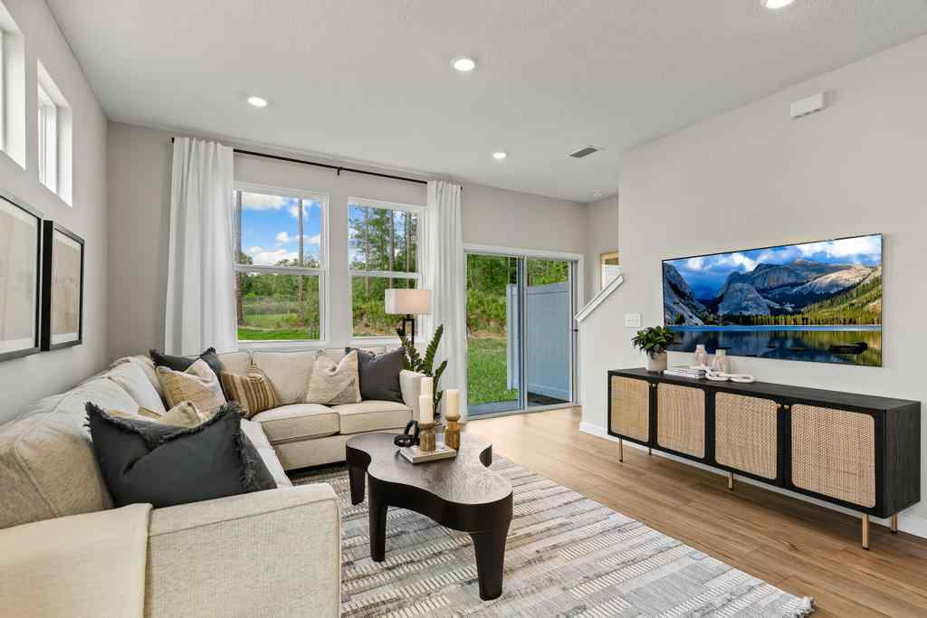 A living room with a large television.